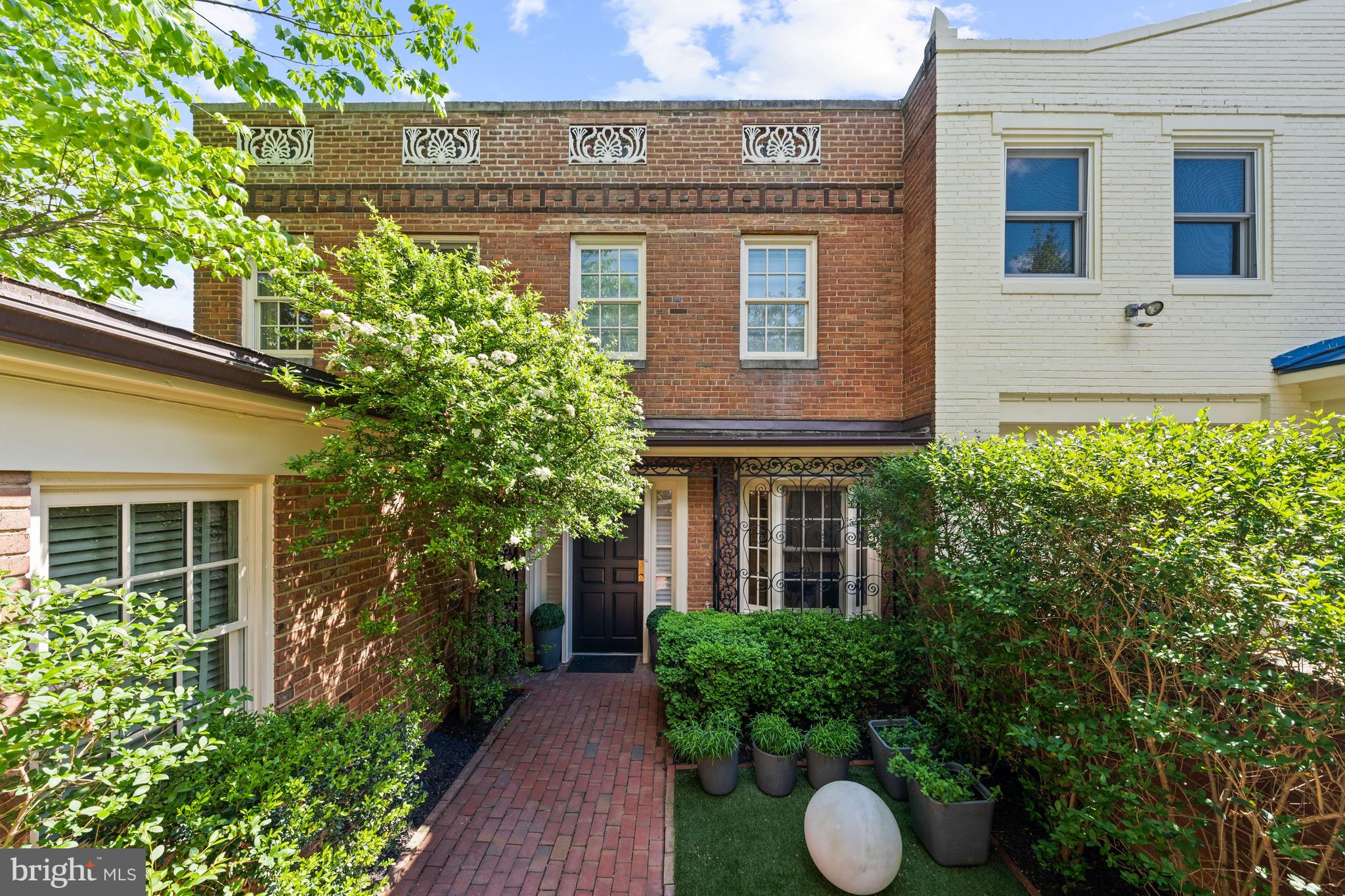 Primely situated in the heart of prestigious Kalorama, this turnkey residence seamlessly blends timeless elegance with thoughtful modern updates across approximately 3,108 total square feet of beautifully finished living space. Offering 4 Bedrooms, 3.5 Bathrooms, lush gardens, a beautiful backyard, and coveted up to 3-car parking, the home presents an exceptional opportunity to enjoy refined city living with remarkable indoor-outdoor connectivity in one of Washington's most sought-after neighborhoods. Designed for both elegant entertaining and comfortable daily living, the home showcases gracious living spaces accented by refinished hardwood floors, tall ceilings, updated lighting, and beautifully improved architectural details throughout. The main level features a formal dining room and gracious living room adorned with a fireplace and floor-to-ceiling french glass doors that unveil a balcony overlooking the beautiful rear lush gardens and provide the space with an abundance of natural light. The renovated Kitchen has been thoughtfully enhanced with refreshed cabinetry to maximize storage, new L-shaped countertop, and new appliances. Upstairs you will find the Primary Suite which features a luxurious spa-like bathroom and dressing suite. Two additional bedrooms with a shared bathroom complete the floor. One of the three bedrooms on this level is currently used as a home office with a full wall of built-in storage and shelving. The fully remodeled lower level offers incredible flexibility with the fourth Bedroom and a fully renovated Bathroom, sizable entertaining space, new flooring, and a newly designed Laundry Room with new full size smart washer and dryer.  Seamless indoor-outdoor living unfolds across the home’s beautifully landscaped grounds, where lush gardens and a serene backyard create an incredibly private urban retreat. Extensive recent improvements, including façade restoration, a new front gate, new roof, added skylights, new air conditioning system and humidifier, and a new water heater, further elevate this turnkey offering. Complete with an attached 1 car garage plus up to two surface parking spots, this beautiful residence has it all! Don't miss out on this rare opportunity!