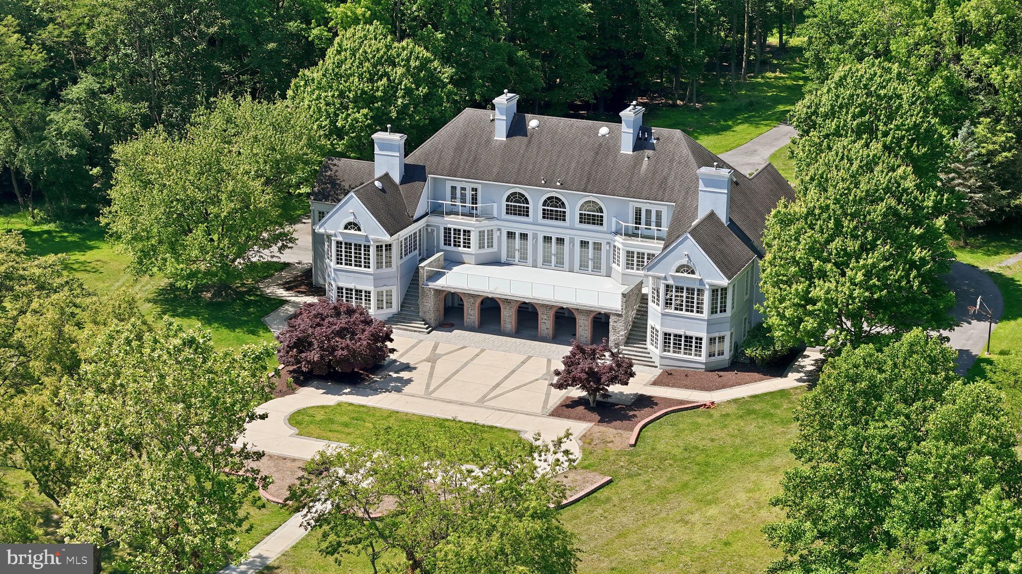 A truly iconic Annapolis offering, this extraordinarily rare waterfront estate is gracefully set on 7.5 remarkably private acres, showcasing what may be the most breathtaking panoramic views in all of Annapolis. With endless, horizon-stretching vistas that evoke the feel of an oceanfront retreat, the Chesapeake Bay unfolds before you with the Bay Bridge creating a dramatic backdrop in the distance, while Annapolis’ beloved summer sailboat races become part of your everyday scenery. A setting of this magnitude—offering serenity, privacy, and commanding water views—is simply irreplaceable.

Encompassing more than 9,000 square feet, this grand residence was thoughtfully designed to maximize its extraordinary setting, with jaw-dropping water views greeting you the moment you step through the front door and drawing your eye through the soaring two-story family room straight to the Chesapeake beyond. The architectural footprint and flow are exceptional, creating the perfect canvas for a visionary buyer to elevate this estate into a world-class showpiece.

The main level is anchored by an expansive waterfront primary retreat, a sanctuary unto itself featuring dual walk-in closets, a spa-inspired bath with a jetted soaking tub, oversized skylit shower, separate vanities, a bidet, and a private spiral staircase leading directly to the lower-level fitness and hot tub retreat. Two additional generously sized en suite bedrooms with walk-in closets are also conveniently located on the main level, along with a richly appointed study/library, elegant formal dining room, spacious kitchen with island and breakfast area, plus an additional family gathering space designed for effortless everyday living and entertaining.

Upstairs, two exceptional en suite bedrooms each offer walk-in closets, fireplaces, private waterfront balconies, and spectacular elevated views that feel suspended above the Bay.

The walkout lower level is equally impressive, designed for entertaining and multigenerational flexibility, featuring expansive recreation spaces opening directly to the waterfront patio, plus a fully self-contained in-law or au pair apartment complete with its own kitchen, family room, full bath, separate entrance, and—of course—those same extraordinary views.

What sets this offering even further apart is the remarkable future potential already in motion. With public sewer and an extraordinary 7.5-acre footprint, the possibilities are nearly limitless. Seller-approved county plans—transferable to the next owner—dramatically accelerate the vision, including plans for shoreline improvements, tree clearing to further expand views, bank reshaping, revetment enhancements, a new tram and stair access to the pier, a widened driveway with a new entrance feature, a detached guest house with its own private entrance from Lyons Dr, a pickleball court, a gazebo, and additional grounds enhancements.

This is more than a home—it is one of Annapolis’ most extraordinary legacy properties, offering a once-in-a-generation opportunity to create an unparalleled waterfront masterpiece.