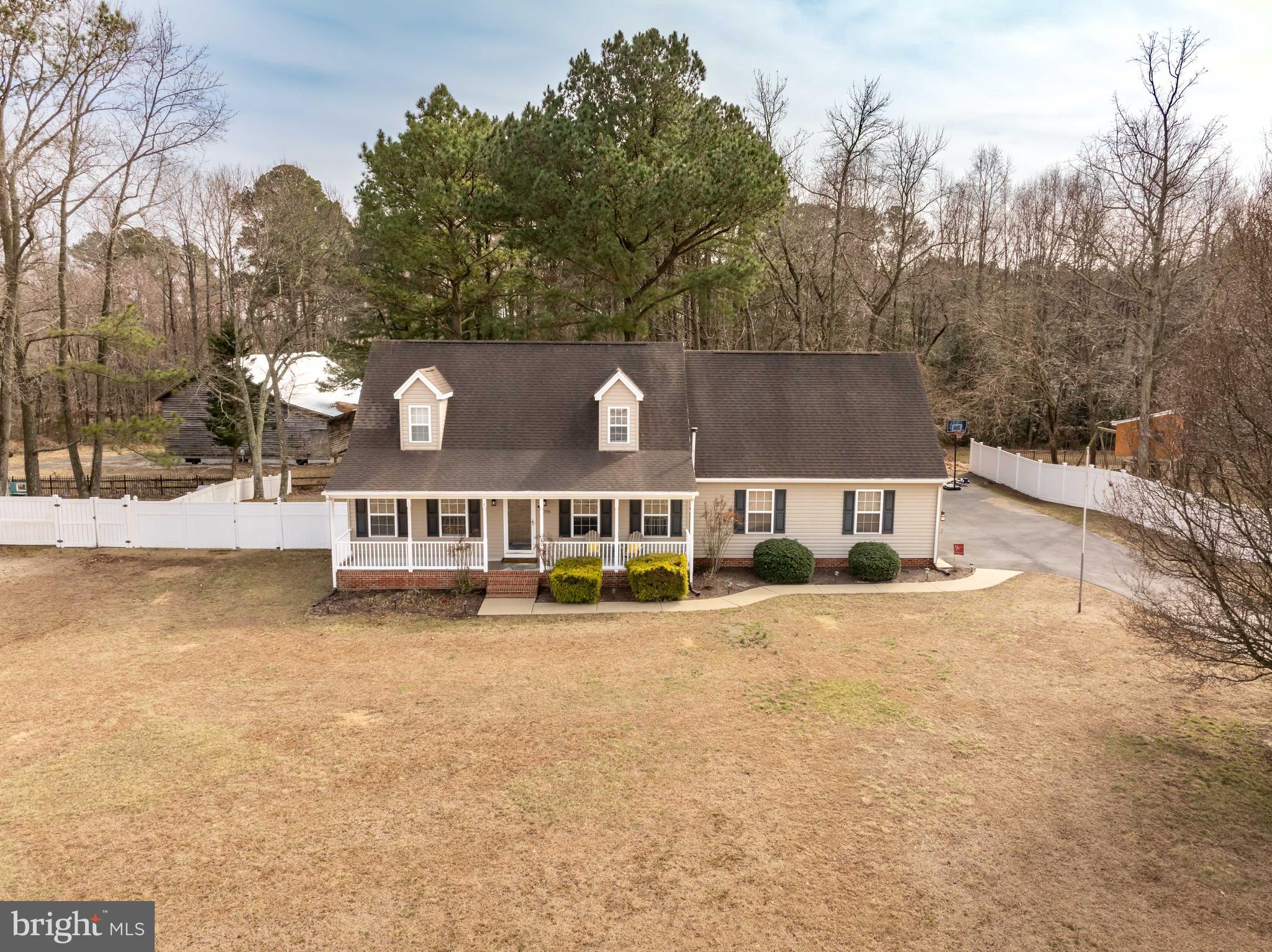 This well maintained home features a first floor primary bedroom, an over sized bonus room, and a spacious lot backing to the Historic Grist Mill (located on nearly 3 acres)! The long driveway leads you to your inviting front porch - perfect for enjoying your morning coffee! Inside you will find a spacious living room instantly made cozy by the extra heat from the pellet stove. Which opens to your kitchen & dining, separate laundry room, half bath, and attached garage. The primary bedroom with a walk in closet - leaving no arguments over where your clothes will go - and a private bath completes the first floor. Upstairs you will find your two  oversized bedrooms, full bath, and a bonus space perfect for a home office, playroom, den, or storage space. Out back you will enjoy spring & summer nights on your large back deck in your fenced back yard! Additionally you have two sheds - one for storage and one for your home gym, office, or craft space! Located in highly desirable Mardela Springs - make your showing appointment today!