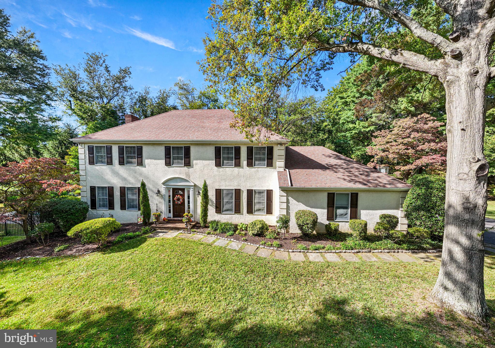 Welcome to this beautiful French Colonial home offering 4 bedrooms and 3.5 baths with over 3,600 square feet of living space situated on 1.26 acres. Tucked away on a quiet cul-de-sac in a highly sought after Bryn Mawr neighborhood, you'll be part of the top-ranked Radnor School District. This home is sure to catch your eye with its stunning curb appeal, highlighted by professionally landscaped grounds featuring trees, manicured gardens, and a sparkling in-ground pool. As you approach, a charming flagstone walkway with Belgium block border leads you to the entrance and into the welcoming foyer. Inside is filled with natural light and features a modern, neutral color palette throughout. The home is designed for easy everyday living and great for entertaining, with a layout that smoothly connects indoor and outdoor areas. On either side of the center Foyer, you'll find the elegant Living Room and formal Dining Room both with hardwood flooring, crown molding, and picturesque views of front yard. These spaces are complemented by a powder room and coat closet. At the heart of the home, the Kitchen and Family Room embrace an open-concept design, featuring ceramic tile flooring and showcasing beautiful views of the private backyard. A chef’s delight, the renovated kitchen features stainless steel appliances, granite countertops, a tile backsplash, and custom wood cabinetry with glass front accents, offering plentiful storage. A 7+ foot center island with seating for 4, a double-door pantry, and recessed lighting enhance the space, while an adjacent Mudroom area within the oversized 2-car garage adds practicality. The Breakfast area flows into the Family Room, with wood-beamed ceiling and a rustic, floor-to-ceiling stone fireplace with custom-built-ins and French doors. Step out onto the spacious, maintenance-free Trex deck with custom awning, which overlooks the serene rear yard and pool. Your private backyard retreat includes a large, rectangular pool with a royal blue mosaic border, diving board, spa, bonus regulation lap lane, all surrounded by elegant black wrought iron fencing.  Accented with beautiful hard scaping garden walls with perennial plantings, the paver patio is the perfect spot for grilling & dining by the pool plus grassy areas to play. In addition to the expanded driveway space for playing basketball and riding bikes, there are multiple yard spaces for playing sports and adding a firepit, gazebo, or swing set. Upstairs, the primary suite features a spacious bedroom, an impressive walk-in closet with built-in shelving and drawers illuminated by natural light, a second walk-in closet (with access to a large floored attic for storage or possibly converted to additional living space), a double door closet, custom wood blinds, and ceiling fan. Spa-like en-suite bath offers dual-sink vanity, jetted tub, vaulted ceiling with skylight, tiled floors, a tiled oversized shower with glass doors, and water closet. 3 sunny bedrooms, each with plush carpeting, ceiling fans, generous closet space, and custom wood blinds, share a full Hall Bath. One bedroom has direct bath access, making it perfect for guests or as a "princess suite." Updated Hall Bath includes tiled floors, a tiled tub & shower, a linen closet, window, recessed lighting, and a conveniently located laundry closet. Finished Lower Level provides almost 1,100 sq ft of versatile living space with Full Bath plus built-in countertop – ideal for a Home Office, homework zone, or arts & crafts space. Additionally, there is ample room for rec/game/movie room, exercise/playroom, or au-pair suite complete with custom closets and storage.  Located near major commuter routes, train station, private schools, and the vibrant Bryn Mawr shops & restaurants. , this home and property offer the best of Main Line living. Don’t miss the opportunity to make this home yours. Schedule your visit today!
