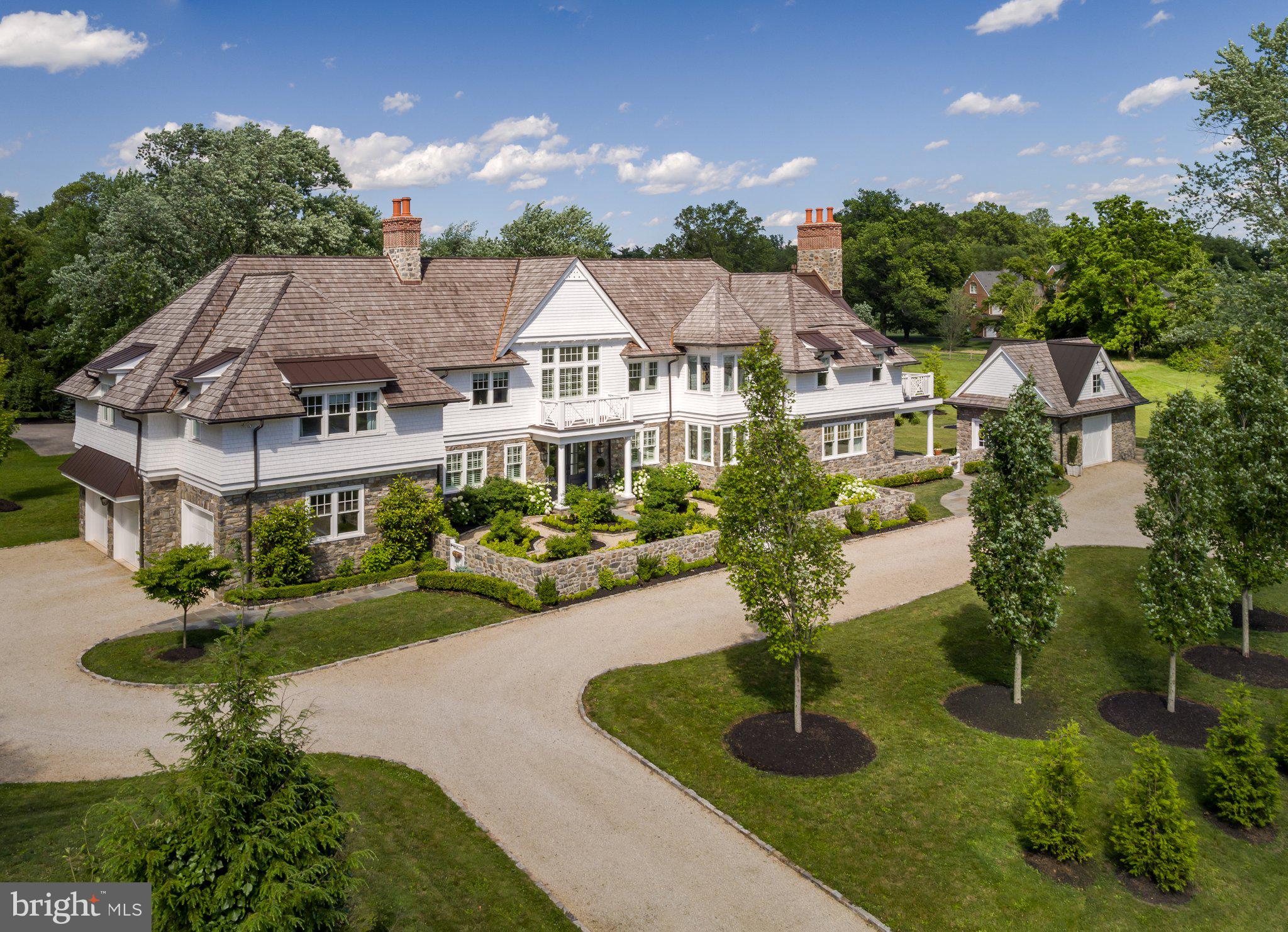 Welcome to this stunning Hampton-style residence, thoughtfully designed by the acclaimed Period Architecture firm and built in 2015 as the builder’s personal home. Situated on 1.54 meticulously landscaped acres in the highly desirable Whitemarsh section of Blue Bell, this property offers the perfect blend of classic architectural elegance and everyday comfort across more than 7,524 square feet of total luxury finished living space.

Inside, every element of the home reflects the builder’s dedication to quality and fine craftsmanship. Wide plank white oak floors flow throughout the house, setting a tone of understated sophistication. The open-concept layout includes five generously sized bedrooms, each with access to 7.5 beautifully appointed bathrooms, including a luxurious primary suite retreat.

The heart of the home is a gourmet kitchen, featuring marble countertops and a full marble backsplash, custom cabinetry, and top-of-the-line appliances. Elegant yet warm, the home also boasts four wood burning masonry fireplaces, offering cozy ambiance in multiple living spaces.

Designed for comfort and efficiency, the home is equipped with gas heating and radiant heated floors, ensuring even warmth throughout the seasons.

Step outside into your own private oasis, where a bluestone patio overlooks a shimmering pool—perfect for effortless entertaining or quiet morning swims. A separate pool house adds convenience, while a full-spectrum infrared sauna offers a spa-quality experience at home. Health and wellness are made easy with a dedicated fitness studio, allowing you to stay active no matter the weather.

The estate is completed by four spacious garages, ideal for multiple vehicles, storage, or workshop use.