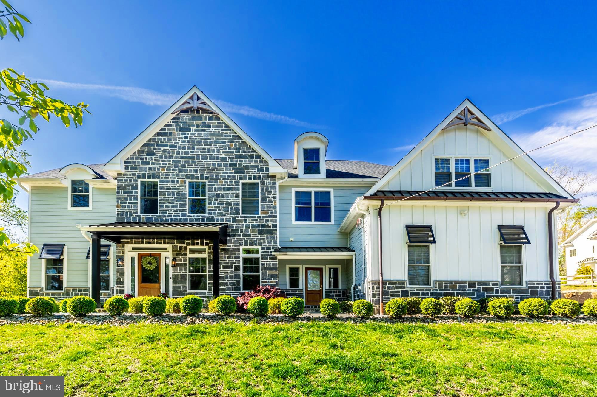 This beautiful craftsman colonial sits in the center of the main line in its own pocket of tranquility, Fully Designer Furnished and ready to move in!  The 5 bedroom 5.5 bath estate features stone walls and hardscaping,  on a large, 1 acre corner property, located minutes from the Berwyn train station.  The exterior is made up of custom hardiboard style siding and stone masonry as well as an accent metal roofs and copper gutters. After walking up your flagstone walk, inside you will find the details carry throughout the house. This includes custom trim , coffered ceilings, wainscoting, wooden accent walks and high end fixtures and finishes. The kitchen features a beautiful, large quartz island and countertops as well as a custom range and hood with pot filler.  A wine cooler and butter's pantry are just some of the additional features on the main floor as well as a bedroom that could also serve as an office. Up the main set of stairs with custom metal railings we find the additional 4 bedrooms and 3 baths. This includes an oversized master bedroom and bath with its own free standing tub and huge walk in closets. The quality of the woodworking and finishes continue throughout the house and lead into the basement. The fully finished and furnished basement is a great spot to entertain guests as well as additional space for your family; including pool table, bar and cinema area. Come see one of the finest houses in the area with a quality,  presence and location that cannot be matched!