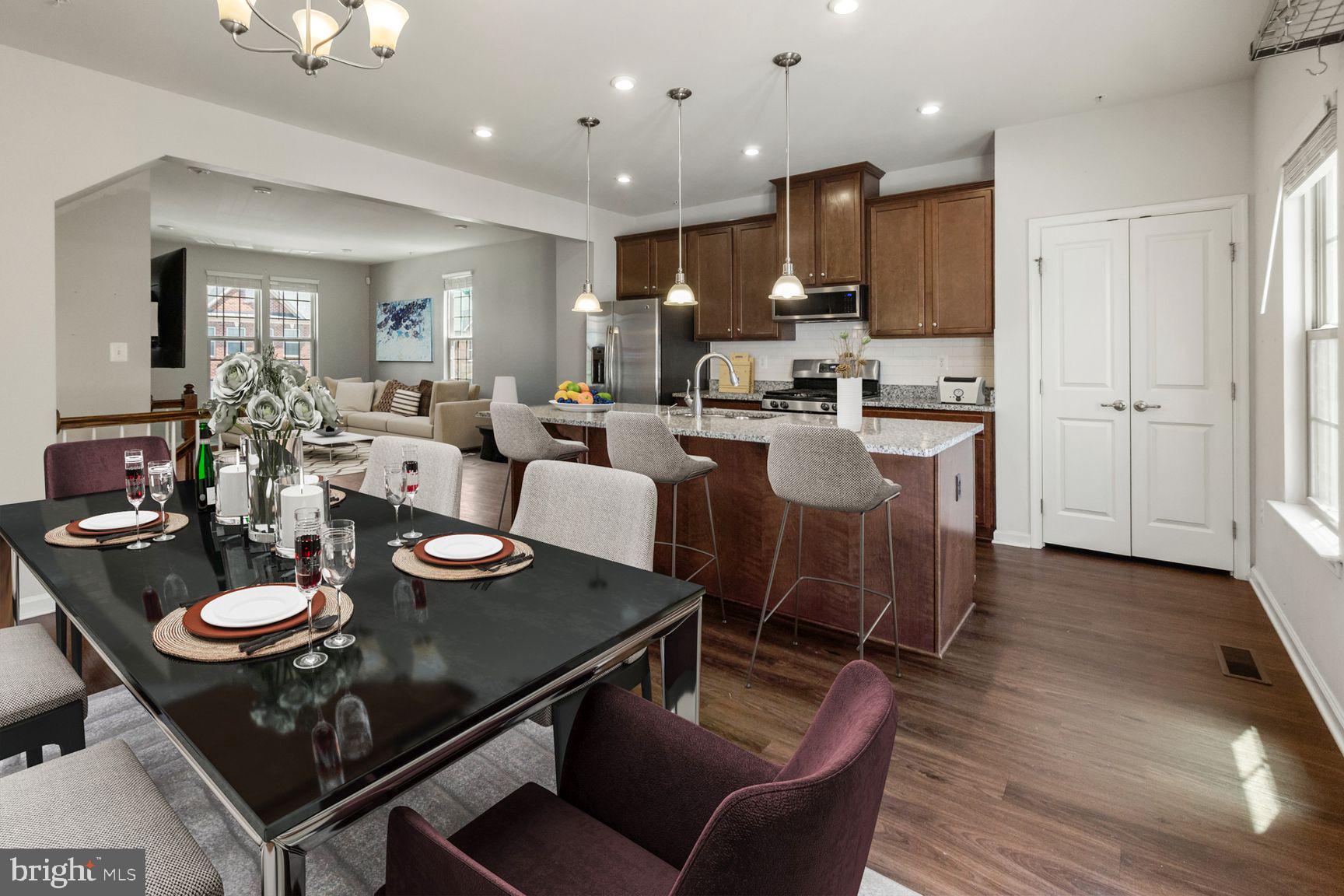 Welcome home to this beautifully appointed end-unit townhome in the highly sought-after Parkside community! Offering 4 bedrooms, 2 full baths, and 1 half baths, this move-in-ready residence combines modern style, comfortable living, and an unbeatable location.

The desirable end-unit design provides added privacy and an abundance of natural light throughout the open and inviting floor plan. At the heart of the home, the gourmet kitchen is sure to impress with upgraded granite countertops, stainless steel appliances, a gas range, and stunning 42-inch cabinetry. Just off the kitchen, a spacious deck creates the perfect setting for morning coffee, weekend gatherings, or relaxing evenings outdoors.

Gleaming hardwood floors flow through the kitchen and dining areas, while the expansive living room offers plenty of space for entertaining or everyday living. Upstairs, the generous primary suite serves as a peaceful retreat, featuring a walk-in closet.

The fully finished lower level provides exceptional flexibility with the 4th bedroom given the legal large window. Also ideal for a media room, home office, fitness space, or playroom. A one-car attached garage adds convenience and additional storage.

Residents of Parkside enjoy outstanding community amenities, including a clubhouse, fitness center, swimming pool, and playgrounds. Conveniently located near shopping, dining, Route 295, and the MARC Train, commuting is effortless. Enjoy easy access to Fort Meade, Baltimore, Annapolis, and Washington, D.C., making this an ideal location for both work and play.

This exceptional home offers the perfect blend of comfort, convenience, and community. Don't miss your opportunity to make it yours!