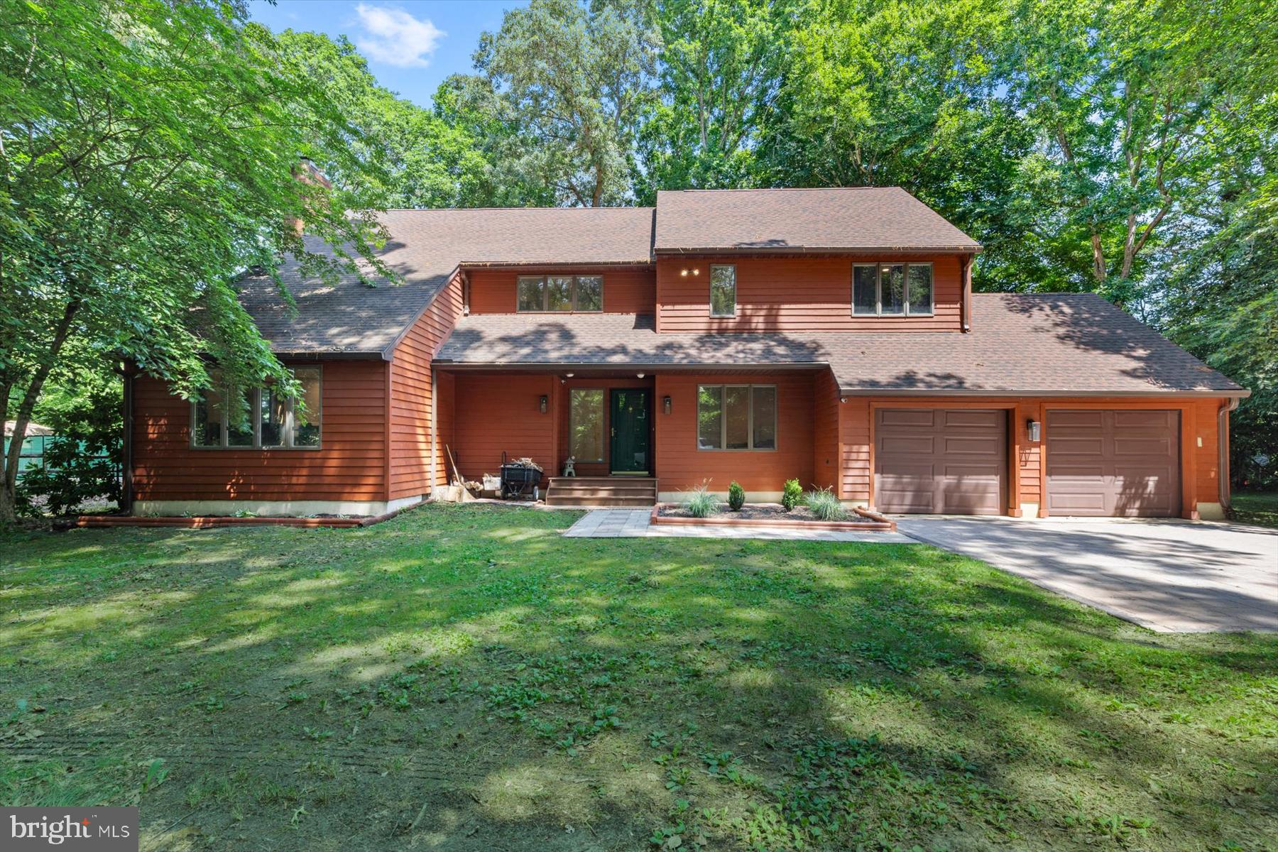 Welcome to a truly exceptional waterfront retreat where luxury, privacy, and modern comfort come together on over 3 acres in Seaford. Completely renovated from top to bottom in 2021, every inch of this stunning property has been thoughtfully redesigned to create a turnkey living experience unlike anything else on the market. Boasting nearly 400 feet of private waterfront frontage, this remarkable estate offers direct access to the water with a private dock, making it a dream for boating enthusiasts, anglers, and anyone seeking a serene waterfront lifestyle. Designed to maximize both comfort and breathtaking views, the home features spacious, light-filled living areas centered around a welcoming family room with a wood-burning fireplace, creating the perfect gathering space in every season. The beautifully updated kitchen is equally impressive, showcasing granite countertops, stainless steel appliances, abundant cabinetry, and a breakfast bar ideal for casual dining and entertaining. The luxurious primary suite serves as a private sanctuary overlooking the backyard, pool, and river. Step onto your own private balcony and enjoy peaceful morning coffee or stunning sunset views over the water. The spa-inspired primary bath rivals a luxury resort, featuring a spectacular walk-in shower, a freestanding soaking tub, dual vanities, and premium finishes throughout. Adding to the home's unique appeal is a hidden secure closet, perfect for storing valuables, important documents, firearms, or other personal items. The walk-up lower level offers exceptional flexibility, providing space for a recreation room, fitness center, media room, workshop, or additional storage to suit your needs. Car enthusiasts, hobbyists, and those needing extra storage will appreciate the rare combination of a 2-car attached garage and a separate 3-car detached garage, providing ample room for vehicles, boats, equipment, and recreational toys. Step outside to your own private resort. The backyard is designed for both relaxation and entertainment, featuring a heated in-ground swimming pool with a retractable cover and plexiglass enclosure that allows for extended, near year-round enjoyment, a built-in hot tub integrated into the expansive deck, and breathtaking waterfront views that create the ultimate outdoor living experience. Whether you're hosting family and friends, enjoying water activities from your private dock, or simply unwinding while taking in the tranquil river views, this property offers a lifestyle that is difficult to replicate. Combining luxury finishes, extensive renovations, unmatched garage space, resort-style amenities, and nearly 400 feet of waterfront, this is a rare opportunity to own one of Seaford's most impressive waterfront estates. Photos may be virtually staged.