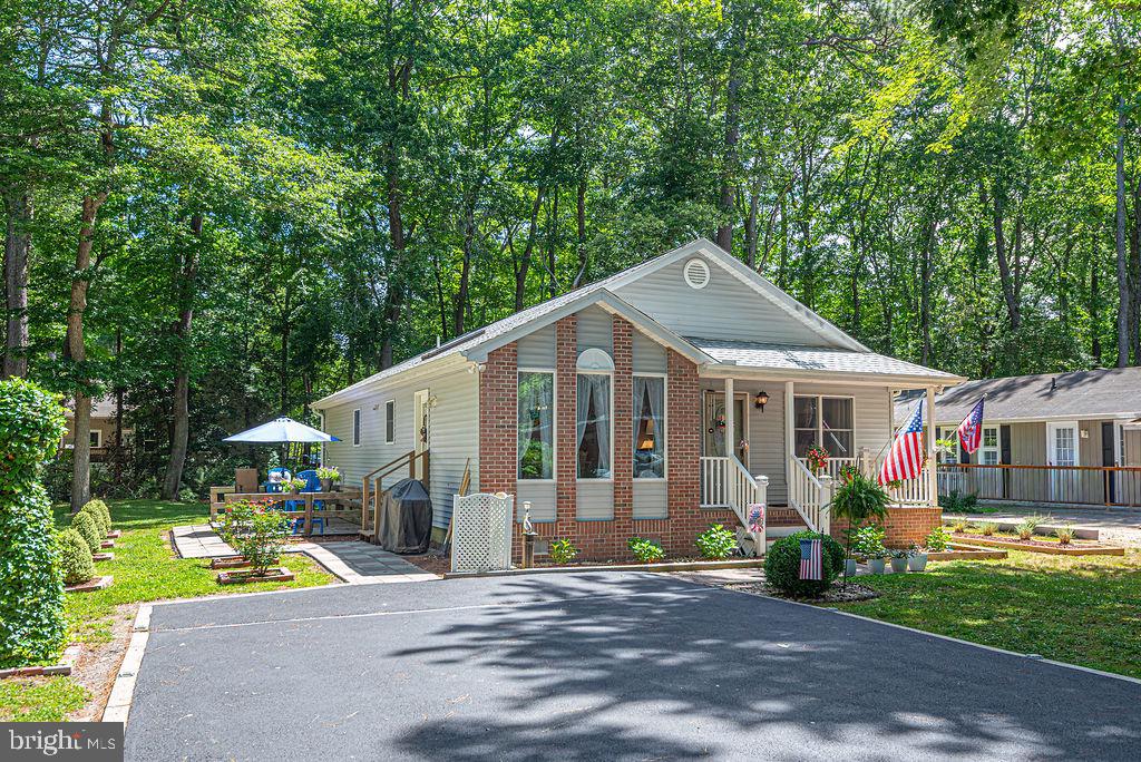 Beautifully maintained and move-in ready home located in the amenity-filled community of Ocean Pines! Recent improvements provide peace of mind, including a new roof (April 2026), new luxury vinyl plank flooring and carpet (2025), new water heater (2025), and new dishwasher (2025). Additional features include an encapsulated crawlspace with sump pump, Andersen windows, interior repainting, and stainless steel appliances, including a refrigerator, microwave, and stove (2020).

The thoughtfully designed floor plan offers vaulted ceilings, a breakfast bar, separate laundry room, coat closet, two linen closets, and a floored attic for additional storage. Enjoy outdoor living from the covered front porch or the ground-level deck, perfect for relaxing, entertaining, or enjoying the coastal lifestyle.

Conveniently located near Ocean Pines' many amenities, including pools, parks, marina facilities, yacht club, golf course, walking trails, and more. Whether you're searching for a primary residence, vacation getaway, or investment property, this well-cared-for home is ready for its next owner. Most furnishings are available for purchase separately for $6,000, offering an easy turnkey opportunity.