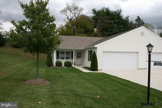 Must see!  This home has a different layout with a mud room/workshop between the kitchen & the garage.  Large dining area w/patio doors to the back porch w/ views of the woods behind.  Oak kitchen w/breakfast bar. Display cabinets over the sink.  2 car garage w/attic storage above.  Heat pump w/humidifier. All appliances included.  50+ community w/low condo fees.