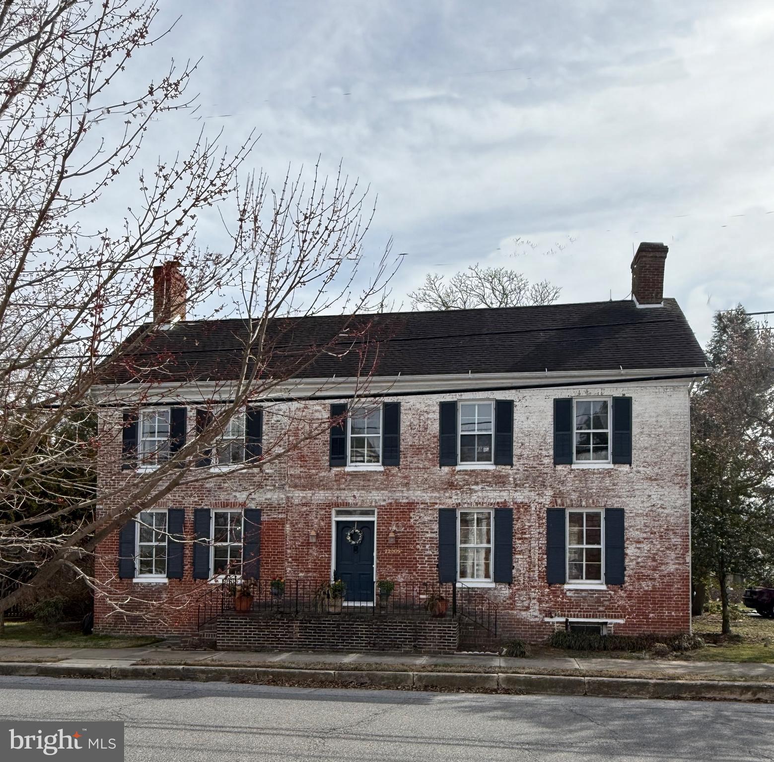 PLEASE NOTE  that the  Owner has listened to the current market, Price has been reduced to $525,000. It is a property of beautifully preserved quality on ¾ of an acre in an urban setting. Most unusual! When compared to equivalent historic properties it is now very competitively priced!

This fine, brick dwelling originating from the18th c. is situated in Hillsboro on Maryland's peaceful Eastern Shore. Hillsboro, nestled along the Tuckahoe River, conveniently located to all that is important to the Eastern Shore's sought-after lifestyle. Public landing with dock and kayak lauch is just a block away. 

The WILLIAM  SMITH HOUSE, built in 1794, exemplifies the world of a successful Grain Merchant living in an important hub for grain and tobacco. The house has been altered slightly through the many decades, but the character of the original building dominates the architecture and "feel" of its 1794 era.  Its charm and elegance remain. The rooms are commodious and inviting. The grand center ENTRANCE HALL is punctuated by the graceful stair, fine woodwork and doors. The LIVING ROOM, as expected, is spacious and comfortable with fireplace (now gas fired), original floors, and bookshelves. The DINING ROOM, of a grand size, features a fireplace (now gas), cabinetry and glass front cupboards. Two steps down from the dining Room the fully equipped KITCHEN is found with wood floor, exposed rafters and back stairway. Open from the kitchen is the GATHERING ROOM with wood floor and wide views of the grounds and gardens. A paver path from this room leads to the driveway and parking. An open DECK offers a secluded retreat off the kitchen wing

BEDROOMS and BATHS are found on second floor. Two of which have fireplaces although decorative at this time. Access to the bedroom level is either from the main grand stairway or via the back stairs. Adding to the charm is the back stair hall in the primary bedroom wing located over the kitchen and "gathering" room. The baths are delightful. 

A surprise outbuilding is to the rear of the grounds. A perfect spot for an office, studio or storage.  Another smaller outbuilding offers more storage. The grounds feature tall mature trees and fencing. The William Smith House is all one would expect built in a gracious era with a colorful history. 
WHERE IS HILLSBORO??  Hillsboro lies a short distance from both Denton, Caroline County and Easton in Talbot County. Chestertown, in Kent County, is just 40 minutes. Annapolis, the Capitol of Maryland, is less than an hour. Unique shops, sailing facilities, live theater and restaurants abound. Hillsboro is from 1- 2 hours from the "rest of the world" for BWI, National and Philadelphia airports are a swift drive away. Dulles a bit further. A private airport is found in Easton. - 15 minutes.  Atlantic Ocean resorts are about an hour. Adkins Arboretum is 1.5 miles. Adkins is a 400-acre native garden and preserve, provides exceptional experiences in nature to promote environmental stewardship. The Hillsboro Public Landing on the Tuckahoe is just a block from property. This property and lifestyle is an enriching experience” It awaits its next steward(s).