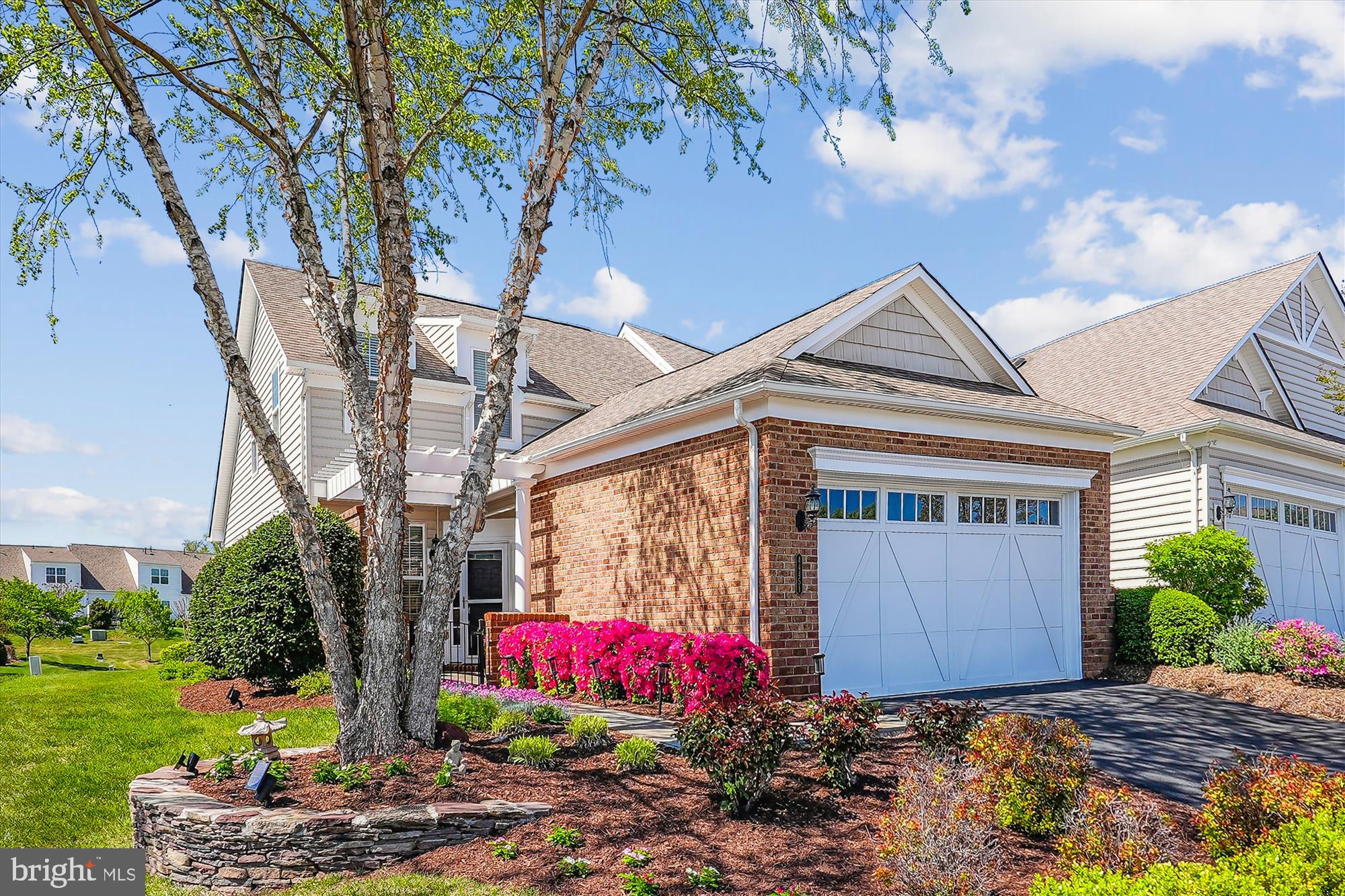You will be so delighted and find a big smile on your face when you see the beautiful landscaping! Enjoy all the vibrant colors from your front slate patio to your backyard paver patio with sitting wall. Welcome home to this 3 bedroom 2.5 bath home. What a great time to find your new home and enjoy all Potomac Green has to offer.  Kitchen features gas cooking, granite countertops, backsplash, pantry and breakfast bar.  Spacious open living room with vaulted ceiling, gas log fireplace, sliding glass door to patio with beautiful views of backyard and open space beyond. Dining room great for guests or intimate dining. Floorplan is open so you have the wonderful views whether dining or relaxing in the living room. King size primary bedroom offers a walk-in closet, bath with double bowl vanity, walk-in shower and linen closet. Main level laundry room with laundry sink, wall cabinets, shelving and washer and dryer convey. 
On the upper level you will find a loft, great for relaxing, watching TV,  playing  games or an office, whatever you need. The loft is a nice, bright open space overlooking the living room. Both bedrooms on the upper level are spacious, the front bedroom has a walk-in closet. HVAC room features extra storage space. The carpet on the stairs and upper level was replaced last year.
Two car garage provides some shelving for extra storage.
You will be glad you found this lovely comfortable home, offering everything on your list,  ready for you to begin your next adventure!