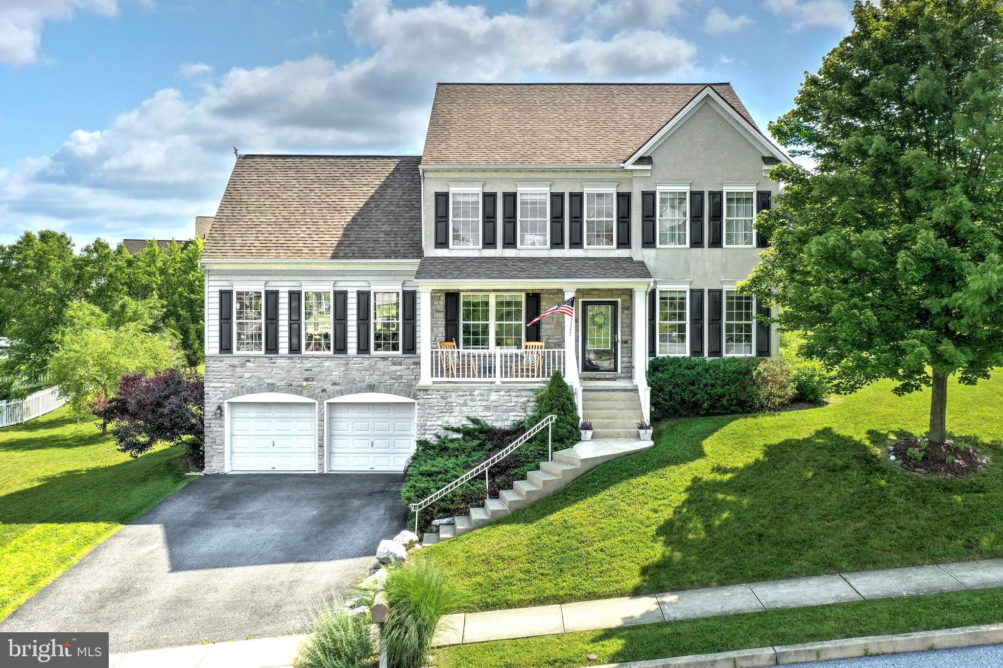 Welcome Home to 779 Connolly Drive , a  4 bedroom , 3 1/2 bath 2 story in the popular Sage Hill  Community of the Dallastown School District. With it's inviting  front porch , light filled , open floor plan , lots of windows , and 9 ft ceilings , this home offers a stylish , easygoing attitude that's perfect for today's lifestyle. The 2 story foyer with hardwood floors opens through french doors to an office with crown molding and hardwood floors or to the living room with hardwood floors. The chef's delight kitchen boasts SS appliances , granite counter tops , subway tile back splash , large  island and pantry . The kitchen flows to the formal dining room featuring hardwood floors , chair railing and crown molding or to the delightful sun bathed morning/sun room with cathedral ceiling.  Adjacent and also open from the kitchen is the very spacious family room with a gas fireplace ,   custom wall unit , carpet  and walls of floor to ceiling windows . The views of the sunsets are awesome !  On the upper level is the owner's suite offering a spacious bedroom and  pampering bathroom with whirlpool tub , separate shower , double bowl vanity and walk-in closet with organizer system . Three additional bedrooms share the main bath . You'll love the finished lower level .  You can watch TV or relax in the family room complete with built ins and counter space for casual meals or homework ! Adjacent to the family room and up a few steps is the unique and creative play room area for the kids !  Everyone can watch TV or enjoy hanging out in  the custom  wet bar area  complete with  counter tops and cabinetry which pair perfectly with the modern farmhouse/industrial style finishes and pendants . All bar stools in lower level are included , as well as the TV on the mirror . There is also a full bath with tile floor and a mudroom area with built-ins . Outdoor  entertaining  , watching  sunsets or movies with friends and family will be fun on the large , custom deck overlooking the rear yard enhanced by a variety of trees , bushes and vegetable garden boxes . The 2 car garage completes the picture ! This home is ideally located to schools, hospitals and shopping .