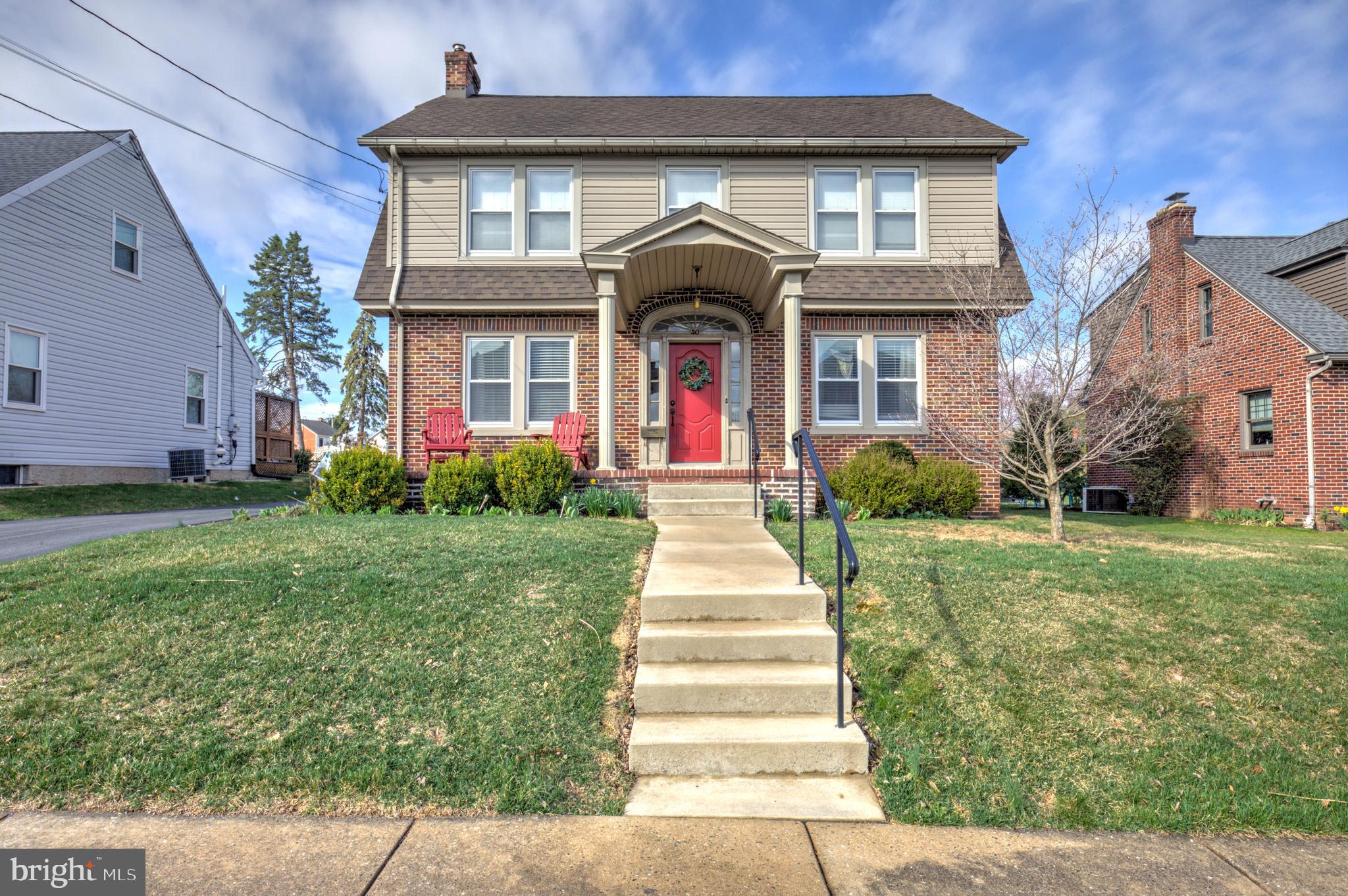 Beautiful Restored Dutch Colonial in New Holland Borough - A True Gem! The maintenance-free exterior showcases a mix of brick, slate, and vinyl, complemented by aluminum-clad trim and energy-efficient double-pane vinyl windows. Inside, you'll find hardwood floors, classic millwork with tall baseboards, and vintage glass doorknobs, enhancing the home's timeless appeal. The kitchen features custom cherry cabinetry that flows into a bright and inviting dining room. The screened porch leads to a 18' x 14' deck, ideal for relaxing or entertaining outdoors. The spacious living room is anchored by a beautiful brick fireplace, adding warmth and character to the space. The upper levels offer four cozy bedrooms, along with a stunningly remodeled full bath. Additionally, there is a second full bath conveniently located on the first floor. Outside, the matching brick 2-car garage enhances the home's curb appeal and sits on a level, well-maintained yard - perfect for gardening or outdoor activities. The garage has been thoughtfully transformed into the ultimate gathering space, offering plenty of room for entertainment. Whether you choose to enjoy this current setup or revert it back to a 2-car garage, the possibilities are endless! This home combines old-world charm with modern amenities and is truly a must-see. Schedule your tour today!