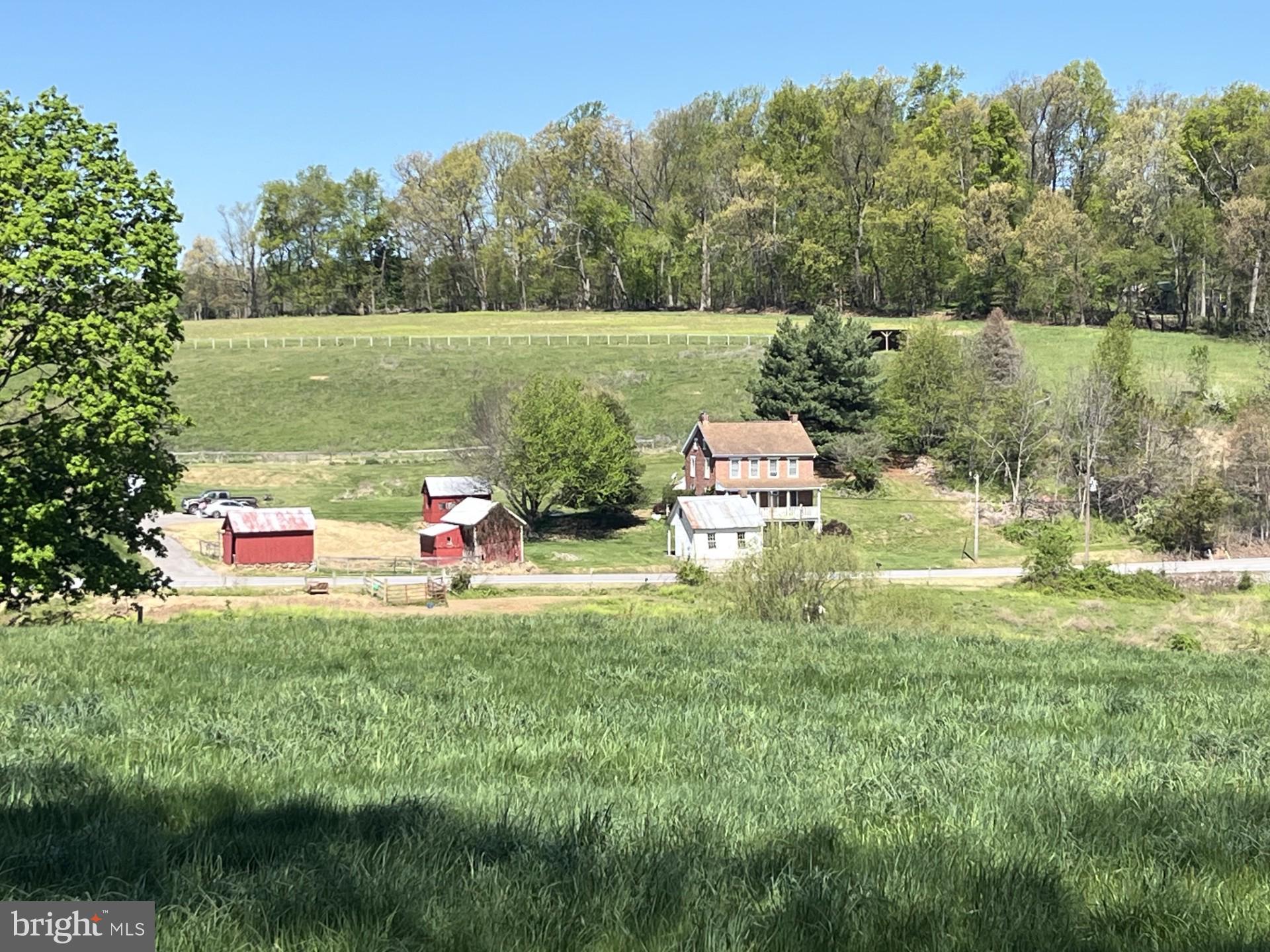 Need some space to spread out? This property has it! This beautiful 25+ acre farm is well suited for you, your animals, and acres of crops. This 2 bedroom, 2 bath farmhouse features brand new roof, (2026) upgraded 200 amp electric, and includes a gas backup generator system.  Additional room accessible from master bedroom perfect for a nursery or office area. Beautiful original wide plank wood floors and deep window wells add to the charm of this unique property. Situated just a short drive from the Maryland line and route 83, this is great for commuters who want a taste of country living.  
Property spans both sides of Hildebrand road.  Total of 25.3 acres. Roughly 15 are being tilled now (by the neighboring farm), +/-3 more could possibly be added. According to county records, one remaining 1 acre lot may be subdivided. Two fenced areas (one on each side for the road) suitable for livestock.  (Most recently horses). Registered as clean and green, saving you $$ on taxes. See this one today!