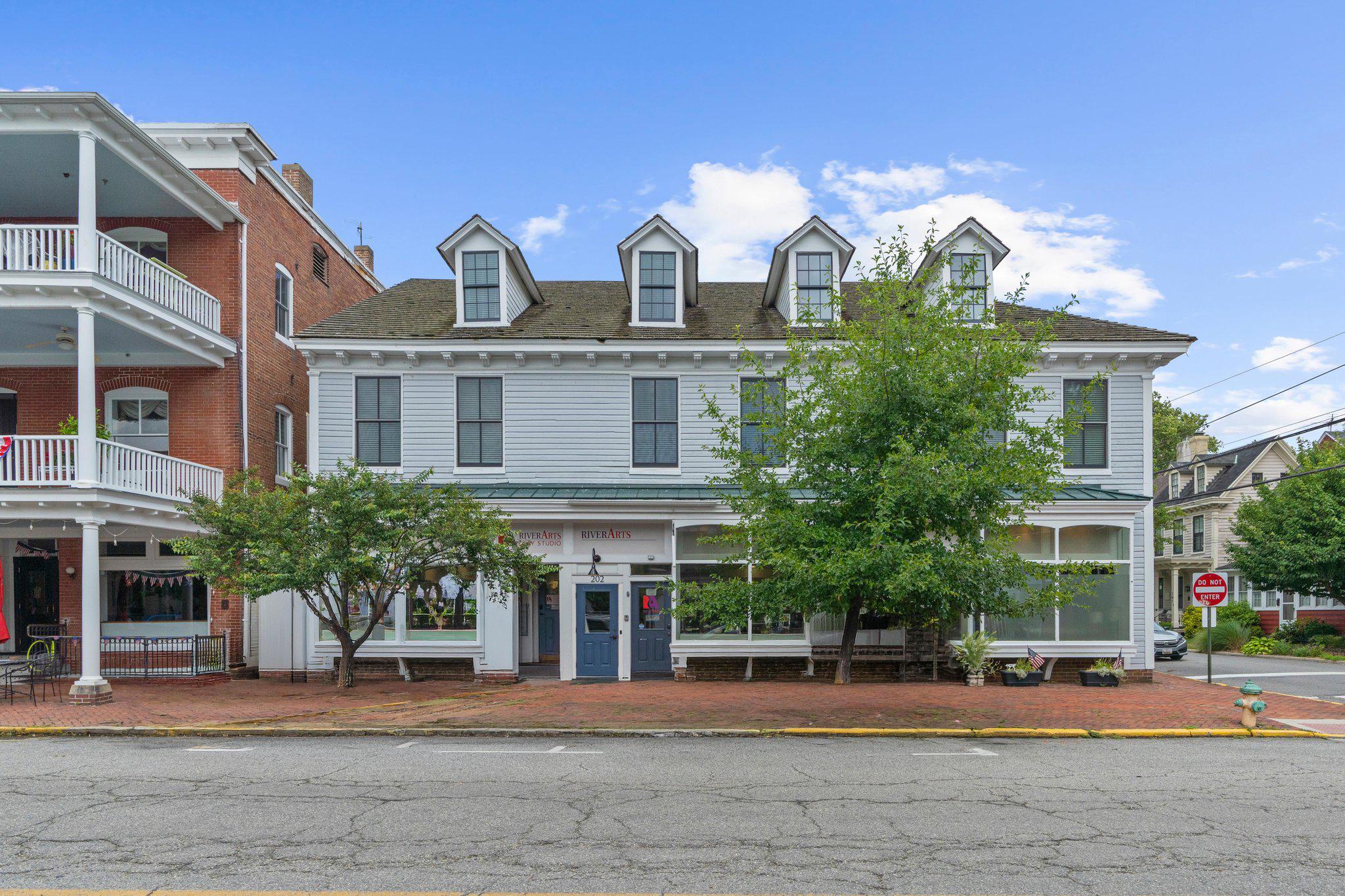 A rare turnkey, profitable, investment property in downtown Chestertown.  Renovated to the studs in 2022, 200-202-204 High Street has 5 apartments and 3 storefronts and since renovations has had no vacancies, with solid leases in place.  During the renovations every major system in the building was replaced, includin new electric service, meters and new wiring throughout, all new plumbing using PEX, new water and septic service lines to the building, new energy efficient water heaters and appliances, rebuilt foundation, new Jeldwen Auralast windows, insulation and air sealing, new roof on rear portions of building (front 50-year cedar roof was replaced in early 2000s), new water rear egress, a monitored fire alarm system and much more.  
Two of the storefronts are rented to a local arts non-profit and a yoga/pilates studio recently moved into the third commercial space.  The 5 apartments consist of two 2-bedroom units and three 1-bedroom apartments.  The steady income stream from the units is complemented by a generous property tax credit through 2032 (buyer to verify transferability).  The property also has a Limited Lead-Free certificate, which requires only an exterior visual inspection every two years, and exempts the owner from MDE registration requirements.  Complete income and expense information available after signing a confidentiality agreement.  Limited photos posted for tenants' privacy.
Contact for a private tour today.  Please do not disrupt the businesses, they are tenants and the businesses are not part of the sale.