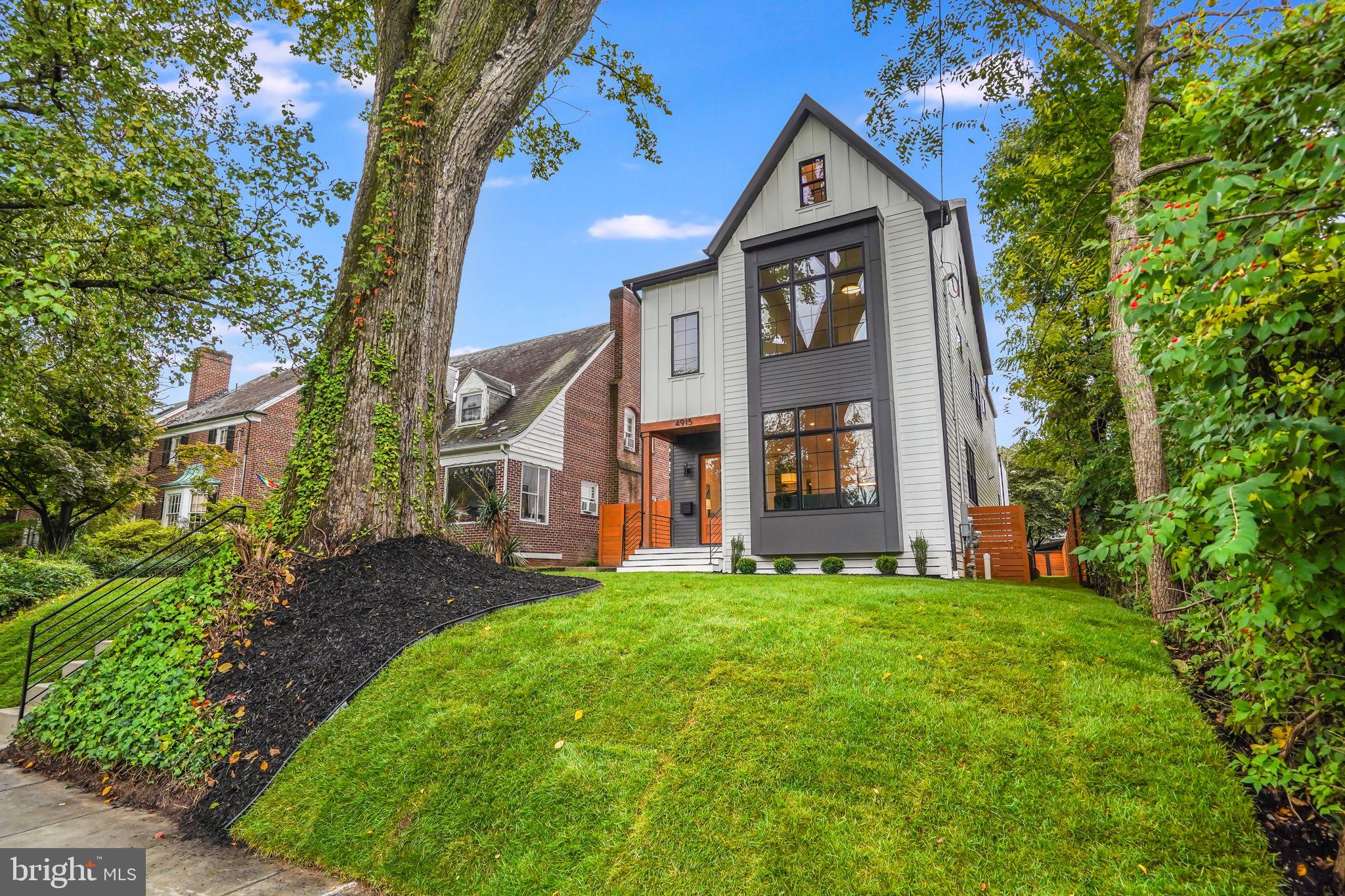 Welcome to 4915 Western Avenue NW, a stunning new construction single-family home located in the highly sought-after neighborhood of American University Park. This masterfully designed & impeccably finished 4-level residence boasts a 2-car garage & a separate guest house, offering over approximately 5,500 square feet of luxurious living space.

As you step inside this exceptional home, you'll immediately be captivated by the exquisite attention to detail & craftsmanship that sets it apart. The main level greets you with soaring 10-foot ceilings, warm wide plank wood floors, & an abundance of natural light streaming in through large Pella Casement windows with elegant transoms. The living room is adorned with an impressive stone fireplace feature, creating a cozy & inviting ambiance.

The dining space, centrally located on the main level, is elegantly illuminated by designer lighting & flows seamlessly into the butler's pantry, featuring stunning countertops with porcelain backsplash. A sliding door opposite the butler's pantry leads into a generous kitchen pantry, offering exceptional storage solutions.

The gourmet kitchen is a true masterpiece, showcasing luxurious countertops & cabinets, a substantial island with a waterfall edge, & top-of-the-line Thermador stainless steel appliances, including a commercial-grade 48" gas range with dual ovens as well as additional wall ovens, including a speed oven/microwave. This home is replete with built-in features, stylish lighting, & porcelain accent walls, all contributing to the home's quality & character. The home's cabinets have been finished with LED lighting, both under them & inside the array of glass cabinets, providing a modern & aesthetically pleasing addition to interior design. These LED lights serve both functional & decorative purposes, enhancing the overall ambiance of the rooms while providing practical illumination.

The spacious yet cozy family room is a focal point on the main level, featuring dramatic black French slider patio doors that open to the outdoor space, allowing for seamless indoor-outdoor living & entertaining.

Venturing to the second level, you'll discover four generously sized bedrooms & three full bathrooms. The main bedroom suite is a true retreat, boasting two walk-in closets with upgraded closet systems & an en-suite bathroom that rivals a spa-like oasis.

Ascending to the third level, you'll find a versatile loft space that includes a large bedroom area with cathedral ceilings, a luxurious full bathroom, & a spacious living area with a vaulted ceiling & a wet bar. This living area leads to a 340-square-foot terrace, perfect for relaxing & taking in the surroundings.

The walk-up lower level offers another level of living space, featuring a large recreation room centered around an elegant wet bar with built-ins, a wine & drink refrigerator, & a glass-enclosed wine storage. Additionally, there's a luxurious full bathroom & an additional bedroom on this level. Separate media room is wired for 5.1 surround sound with speakers installed & is wired for cable and internet. 

Outside, just across the patio, you'll discover the two-car garage with stairs leading up to a fully finished 500+ square foot versatile living space, complete with a full bathroom.

This exceptional home also includes built-in speakers throughout, a Nest system, & a Ring system, ensuring your comfort and peace of mind. You will find internet access points & wiring for cable & internet throughout. 

Enjoy the convenience of this desirable location, with easy access to numerous parks & less than a mile from the Friendship Heights Metro station & all its surrounding shops and dining options. Plus, it falls within the Janey/Deal/Jackson Reed school boundary. Don't miss the opportunity to make this luxurious new construction property your dream home in American University Park!