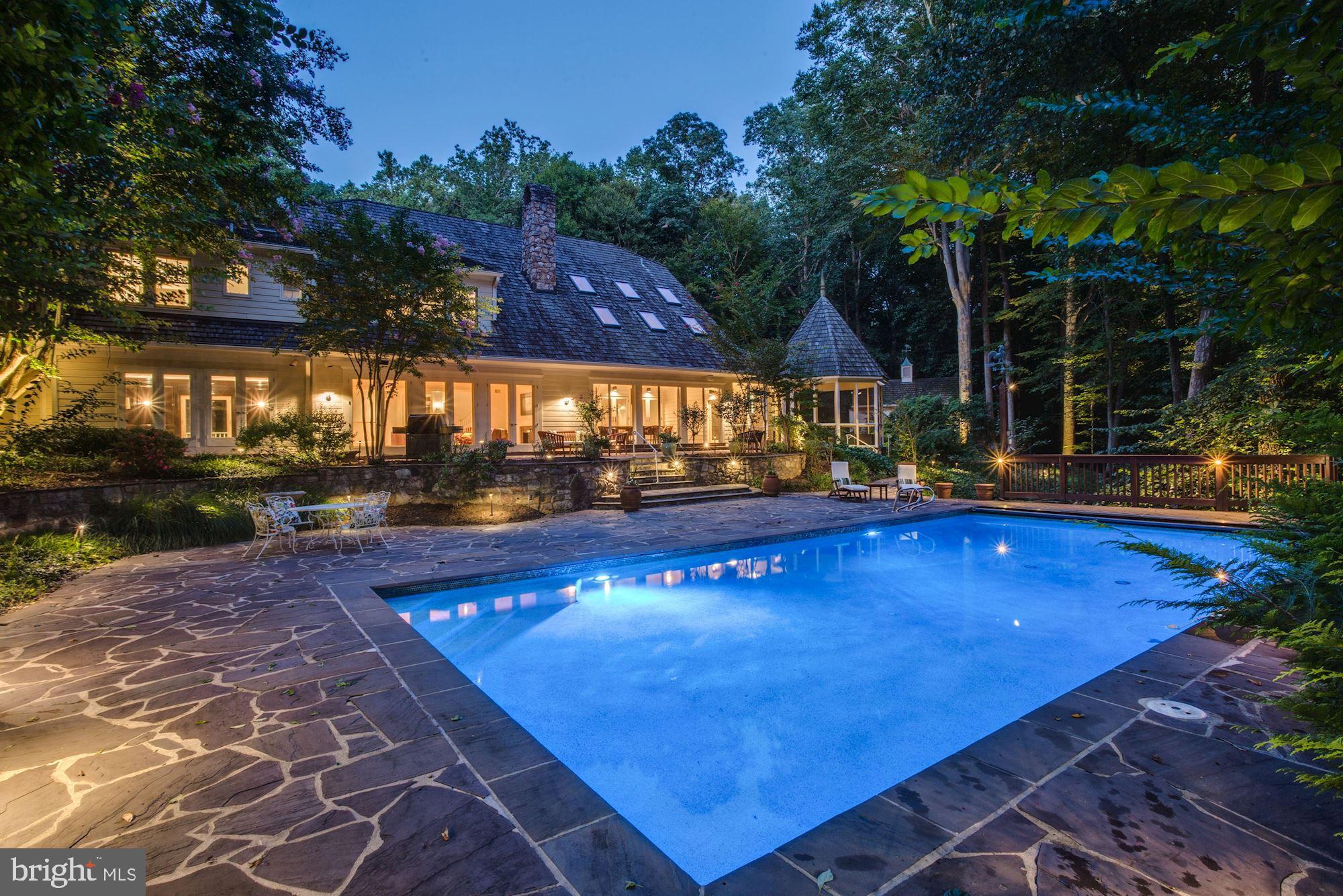 NEW PRICE! Beautiful, custom-built residence on a private 7+ acre setting in the heart of Potomac backing to C&O Canal National Historical Park. Expansive home with gourmet kitchen, wood-paneled great room, 3 season porches with double-sided gas fireplace, luxurious master suite, renovated bathrooms throughout, lower level with large recreation room, bar, & exercise room. Outside feels like a private retreat and features a pool, tennis court, patios, and yard.  Circular driveway. 2-car attached garage & separate 2-car detached Coach House with unfinished area for potential studio. Walk to Great Falls Park through the woods and minutes to Potomac Village!