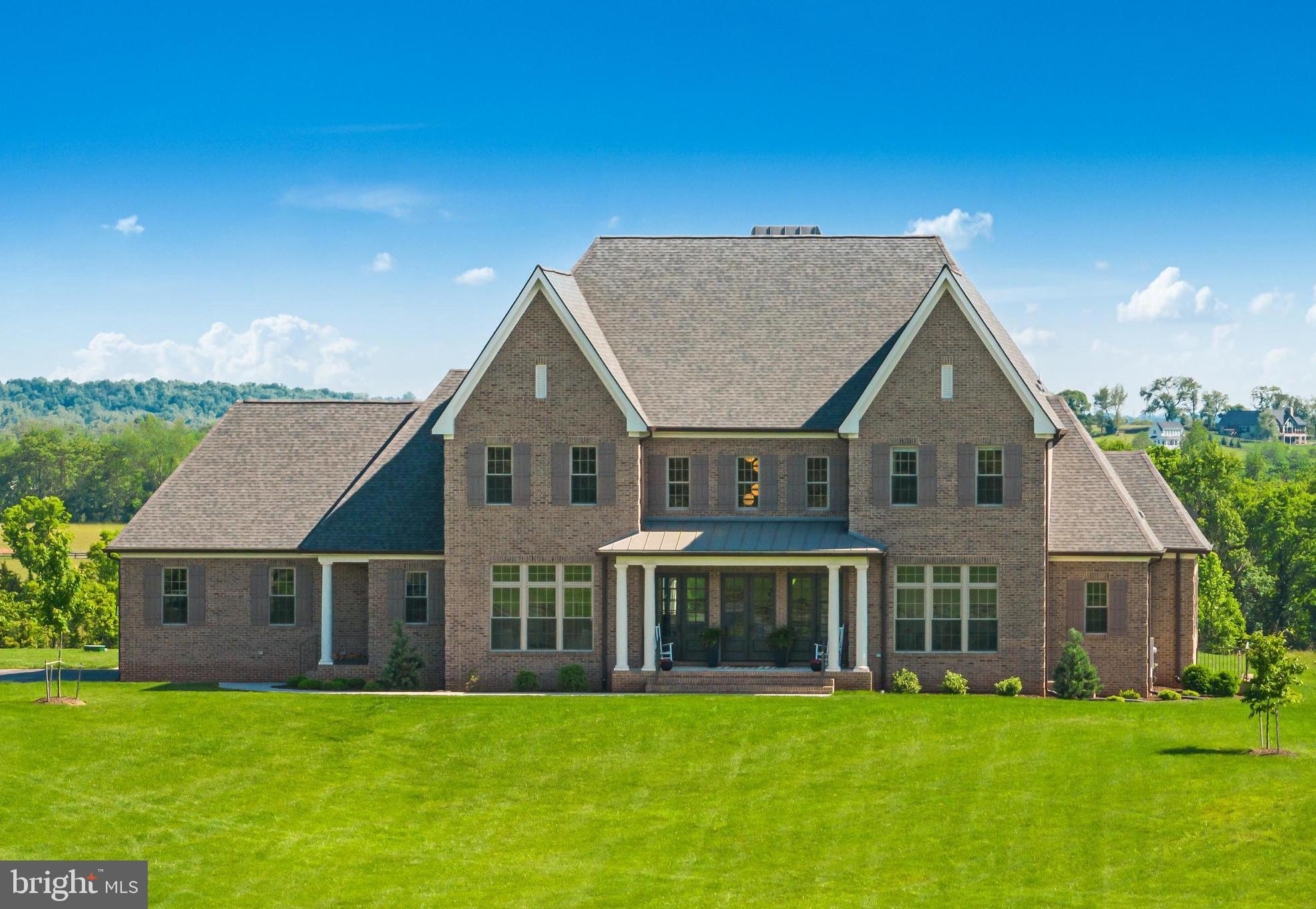 A rare opportunity to own a meticulously maintained modern Colonial in the Leesburg countryside! Custom-built in 2020 by Battlestreet Builders and situated on 11.6 acres, this impressive property offers high-end custom details, beautifully landscaped grounds, and a dreamy pool/spa combo for the perfect indoor/outdoor lifestyle.

The elegant interior features quality craftsmanship and finishes - a centerpiece fireplace, hand picked light fixtures, hardwood floors, custom built-ins and extensive molding, trim, and millwork throughout. The open concept floor plan is thoughtfully laid out for elevated living and offers flexible spaces for formal and casual gatherings alike. Work from home in the formal office, or relax in the spacious family room. The gourmet eat-in kitchen features top-of-the-line appliances and opens up to the dining area and a glass encased wine room, perfect for hosting dinner parties! Just off from the family room is the main level primary suite featuring his-and-hers walk-in closets and a spa-like bath with a soaking tub, dual shower head, and dual vanities. Rounding out the main level is a custom mudroom off the garage with stacked laundry.

5 generous bedrooms and 4 baths upstairs also include conveniently located laundry. The walk-up lower level includes all the amenities your family needs - enjoy a large recreational space, a full gym, and a full 7th bedroom and bath, perfect for hosting out of town guests or to use as an in-law suite.

Incredible outdoor living with a covered patio off the kitchen overlooking the vast countryside and outdoor living space. Enjoy summertime right here in your own backyard with a fenced-in, heated built-in pool with retractable cover and spa. The expansive backyard is perfect for kids and furry friends alike. Located in the desirable Tuscarora High School pyramid and just minutes from world renowned vineyards, breweries, shopping and dining, and just 35 minutes to Dulles Airport, this is a true lifestyle property. Enjoy, and welcome home!