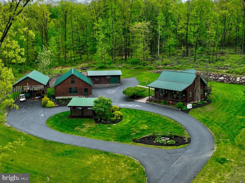THIS PROPERTY IS GOING TO AUCTION ON THURSDAY JUNE 18, 2026 @ 7:00 PM. THE LIST PRICE ONLY REFLECTS THE SUGGESTED STARTING BID. Inviting covered porch overlooking a secluded 11.93 acre wooded lot! This home is in absolute move-in condition with lots of natural light. Features include: living room with stone mantel and cathedral ceilings; fresh paint throughout; kitchen with island and oak cabinetry; mudroom added in 2026; primary bedroom with private bath; recently finished basement with family room, full bathroom, laundry and canning room. The backyard offers a large paver patio and beautiful wood deck. Also included on the property is a 39' x 28.5' oversized 3-car garage with second level workshop; 30' x 22' animal shed with lean-to and 2-rollup doors; large pasture area for horses, beef cattle, pigs, sheep, goats, chickens or turkey; 44' x 24' open pole barn; 16' x 13' firewood shelter; circle driveway. This home offers a charming design and ideal location, close to Rt. 501 and Rt. 897. Property is ready to welcome its new owners. Don't miss out on this opportunity!