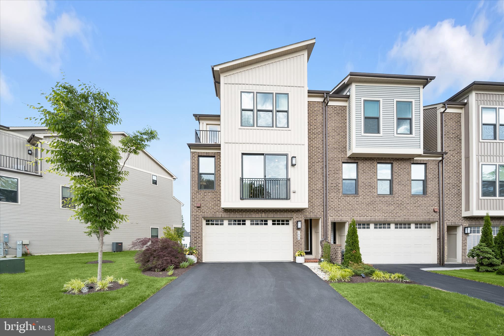 Coming Soon!  Experience elevated living in this stunning end-of-row townhome in one of Columbia’s sought-after newer communities. Showcasing custom upgrades and design-inspired finishes throughout, this exceptional home features a sun-filled open floor plan enhanced by upgraded flooring, stylish lighting, custom laundry cabinetry, upgraded kitchen and baths, window treatments, a 4-foot extended Sky Lanai, and more.  The striking brick-front exterior and covered entry welcome you inside, where the entry level offers a spacious family room with direct access to the stone patio and backyard, along with a powder room, perfect for a home office,   guests,  or flexible living space.  The open-concept main level is designed for both everyday comfort and entertaining, featuring expansive living and dining areas that flow seamlessly into the gourmet kitchen. Highlights include an oversized island breakfast bar, quartz countertops, stylish pendant lighting, a walk-in pantry, and stainless steel appliances. Step outside to the impressive extended Sky Lanai, creating a true indoor-outdoor living experience with a gas fireplace set within a dramatic stacked-stone accent wall.  Upstairs, the luxurious primary suite offers a tray ceiling, a spacious walk-in closet with custom organization system, and a spa-inspired en-suite bath featuring a dual quartz vanity and frameless glass shower with built-in seating and upgraded tile. Two additional bedrooms, one with its own private balcony, a full hall bath, and a convenient upper-level laundry room complete this level.  Outdoor living continues on the expansive stone patio overlooking a common area and tot lot, providing a welcoming setting for relaxation and recreation. Ideally located near major commuter routes, shopping, dining, and entertainment, this beautifully upgraded home offers the perfect combination of style, comfort, and convenience.