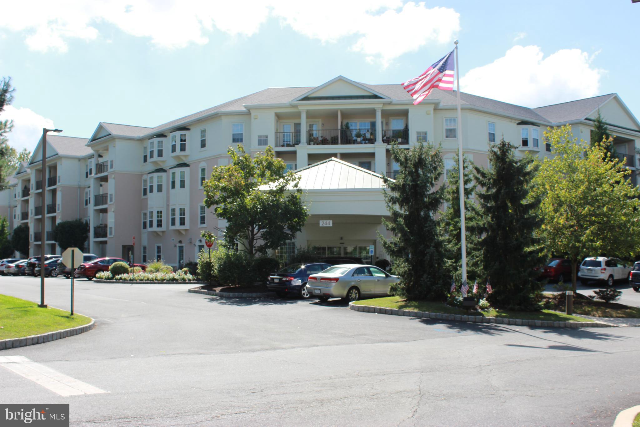 Don't miss this 2 bedroom, 2 bath condominium located in the highly coveted 55+ Windsor at Glen Mills community. Located on the 2nd floor, and accessible by elevator, this unit has been gently lived in, and very well maintained, with only one owner. Enter the unit into a spacious, welcoming foyer with hardwood flooring and a hall coat closet. As you look ahead into the unit, you'll notice the natural light streaming in from the sliders and the hardwood flooring extending through the main living space.  The condominium offers an open floor plan through the main living area allowing for natural light and comfortable living. The dining room will hold several for holiday gatherings or game nights. The living room is adjacent to the dining room and provides access to a lovely balcony where you can enjoy your morning coffee and crossword. No shortage of storage and food prep space in this kitchen! The kitchen offers very nice oak wood cabinets and black appliances including built in microwave and dishwasher. The counter has a breakfast bar with space for a couple of stools for a quick bite or for friends to sit and chat with the chef. Additionally, there is an area for a smaller breakfast table and chairs. The kitchen lighting was recently updated. The laundry room is just off the kitchen and offers a pantry closet for food storage, an additional storage closet and wire shelving. The hot water heater was recently replaced in 2021 and the washing machine is brand new in October 2023. The primary bedroom suite offers a sweet bay window, large walk-in closet, ceiling fan and a full bath with stall shower, white vanity and upgraded tile floor. The shower doors are an upgrade and were replaced in 2020 along with a new, taller toilet. The second bedroom is a nice size for guests or an office with a tray ceiling and closet. The hall bathroom offers a vinyl tub/shower combination, white vanity, upgraded tile floor and linen closet. The balcony overlooks the pool area which is currently being remodeled to include a beautiful inground salt water pool expected to be ready summer 2024! Windsor at Glen Mills is a secure community and offers many amenities and social options. The gathering area on the main level was recently refreshed and is a lovely place to meet friends. Among other amenities, there is a library, business center, billiards room, multiple fitness areas, a craft and game room. There is often a puzzle underway and bingo and mahjong are always on the activities schedule! The community is conveniently located to major routes, shopping and restaurants. This unit has access to a private storage unit in the garage (#54). Garage parking is not included, but outdoor parking is plentiful (2 cars per unit) and there are multiple secure entry doors to the building. Pets are allowed with some restrictions. Almost all utilities are included in the monthly Condo fee. This is a fabulous opportunity to enjoy a carefree lifestyle - make your appt. today!