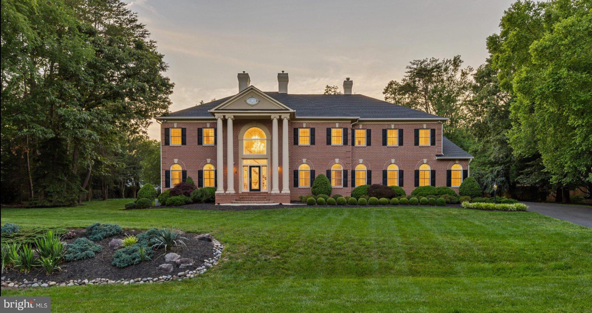 Perfectly positioned on a private, nearly one-acre homesite in the prestigious Severna Park community of Harlequin, this extraordinary custom estate offers more than 8,000 square feet of thoughtfully designed living space, blending timeless elegance with modern comfort. The residence showcases exceptional craftsmanship, grand proportions, and a level of detail rarely found, creating a home equally suited for lavish entertaining and everyday living. Rich hardwood flooring, soaring ceilings, architectural moldings, and custom finishes set the tone throughout the home. A dramatic two-story foyer with a sweeping curved staircase welcomes guests and opens to elegant formal living and dining rooms. Refined principal rooms transition seamlessly into warm, inviting gathering spaces, including a spectacular two-story family room with fireplace, an expansive gourmet kitchen designed for both cooking and entertaining, and a sun-drenched sunroom featuring walls of windows and French doors that connect effortlessly to the outdoor living areas. The main level also offers a private junior suite with bedroom and full bath, ideal for guests or multigenerational living. Upstairs, the extraordinary primary suite encompasses approximately 1,450 square feet and serves as a true private retreat, complete with a sitting area, balcony, gas fireplace, kitchenette, luxurious marble spa bath, and two expansive walk-in closets. Two additional bedrooms connected by a Jack-and-Jill bath and a spacious laundry room with custom cabinetry and abundant storage complete the upper level. The recently remodeled lower level has been transformed into an exceptional recreation and entertainment destination. Designed for gathering and relaxation, the space features a beautifully appointed custom bar highlighted by a stunning tile backsplash wall, beverage and wine refrigerators, and ample room for hosting family and friends. Enjoy a game of pool, unwind in the spacious family room for movie nights and sporting events, or maintain your fitness routine in the dedicated gym with specialized flooring. The lower level also includes a private bedroom with an ensuite bath, providing comfortable accommodations for guests, an au pair, or extended family. Outside, immaculately landscaped grounds create a peaceful retreat, complemented by an oversized Trex deck overlooking the private backyard. Surrounded by mature trees and natural beauty, this exceptional property offers a rare combination of privacy and convenience, just moments from Severna Park's top-rated schools, shopping, dining, and commuter routes.