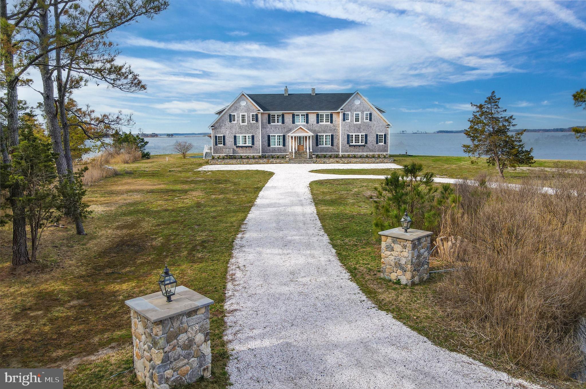 Set on a 2.38 acre peninsula with 1,100 feet of waterfrontage, 1301 Broadview Drive is a thoughtfully crafted waterfront retreat defined by exceptional materials, timeless detail, and water views from every room. The exterior pairs stone and cedar shingles with copper lanterns and bluestone hardscaping for a classic Eastern Shore look, while inside, custom millwork, mahogany accents, brass floor registers, and a refined mix of designer fixtures and finishes create a warm and elevated feel throughout.

The main level is designed for both everyday living and effortless entertaining, centered around an open gourmet kitchen with Shaw fireclay sinks, Waterworks fixtures, marble counters and backsplash, a mahogany island, and a fully integrated appliance suite. A beautifully finished butler’s pantry, breakfast area with custom bench seating, and great room with custom built ins and a gas fireplace with marble surround add both style and function. A dining room, library or office with built ins, powder room, mudroom, and laundry room complete the main level, while the covered deck provides the perfect place to take in the sunset.

Upstairs, the private spaces are equally inviting, highlighted by a serene primary suite with a large walk-in closet, private deck, and a spacious marble bath with soaking tub and custom shower. Additional bedrooms offer custom closets, designer lighting, and beautifully finished baths, while a gym and rear upper deck add to the home’s comfort and flexibility. Outside, sweeping views stretch across the Chesapeake Bay, Little Choptank River, and Fishing Creek, with a waterside pool (as-Is) , pier with lift, boat ramp, and detached storage garage completing this exceptional property. Modern conveniences including Nest climate control, security cameras, fiber wiring in most rooms, and smartphone-controlled dimmers add ease to a home where craftsmanship, comfort, and waterfront living come together beautifully.