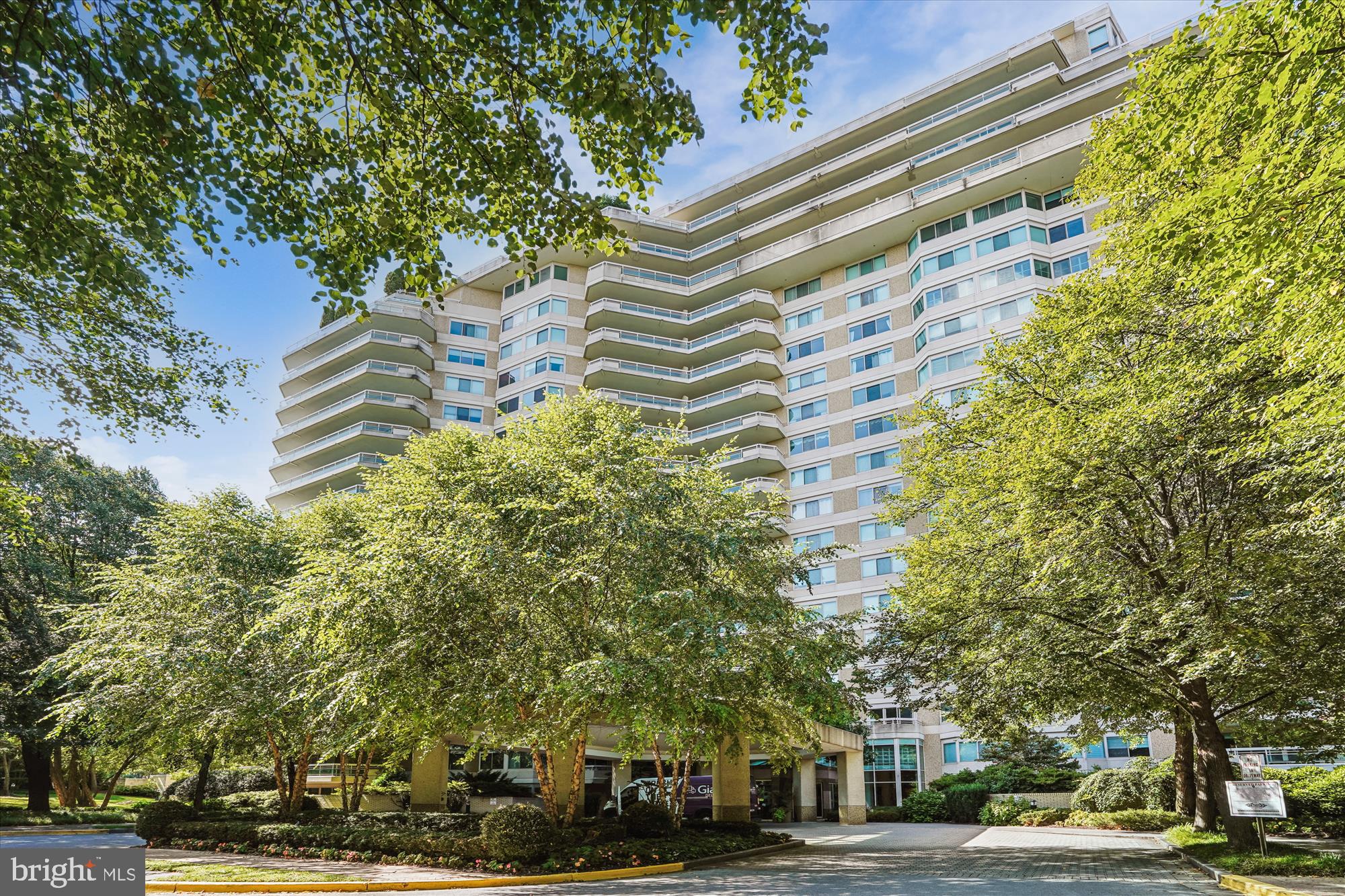 Welcome to this bright 2,064 sq ft condo featuring 2 bedrooms plus a den and 2.5 baths, all with lovely views of the trees. The home opens with a foyer that has two double closets and leads to a kitchen with a pass-through window overlooking the spacious living and dining area. There’s also a separate den and a laundry room. The primary bedroom suite includes a dressing area, a large walk-in closet, and an en-suite bath with both a tub and a shower. The second bedroom has a double closet and its own full bath with a tub and shower. Beautiful hardwood floors run throughout, with marble in the foyer and ceramic tile in the kitchen, laundry, and bathrooms. Two garage parking spaces (G1-117 and 118) and a storage unit assigned by the manager come with the sale. Enjoy elegant, resort-style living in Friendship Heights’ most luxurious complex, set on more than 17 acres. This gated community offers a gatehouse, 24-hour security, beautifully landscaped grounds, and walking paths. Residents can use tennis courts and a three-story clubhouse with indoor and outdoor pools supervised by lifeguards, party rooms, a modern gym, racquetball, billiards, ping pong, and aerobics rooms. The amenities are truly endless. Plus, you’re just a short walk from shops, grocery stores, restaurants, and the Friendship Heights Metro station.
