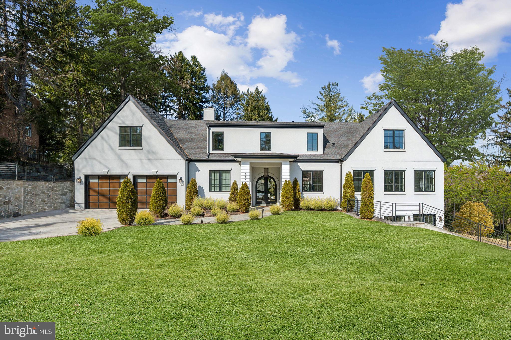 New price = great value!!  This stunning contemporary 6 bedroom/7.5 bath home, constructed in 2018, is situated on a spacious corner lot in highly sought-after Chevy Chase. The open-concept main floor bathes the living and dining room in abundant natural light, creating a welcoming and airy atmosphere. Designed for gracious living and exceptional indoor-outdoor entertaining, the home features large accordion-style doors that open to a private interior courtyard, seamlessly connecting the living and dining areas. The spacious gourmet kitchen features high-end appliances and an impressive island with seating. Upstairs, a luxurious primary suite is a true retreat, complete with two walk-in closets, a spa-like bath, and a private balcony overlooking the serene courtyard. Three other large bedrooms, two more bathrooms, and a laundry complete the second floor. A thoughtfully designed, separate but connected guest house offers complete privacy with its own kitchen, bathrooms, bedrooms, and living spaces—ideal for hosting guests or multi-generational living. The property also includes generous four car parking in two separate garages. Proximity to Rock Creek Park offers walking trails and open spaces for recreation.   A  quick drive or stroll via a neighborhood path takes you to the new Chevy Chase Lake center, which includes a grocery store, restaurants, retail shops,  and live entertainment events.   As an added bonus, the adjacent Purple Line station will make commuting a breeze. Welcome home!