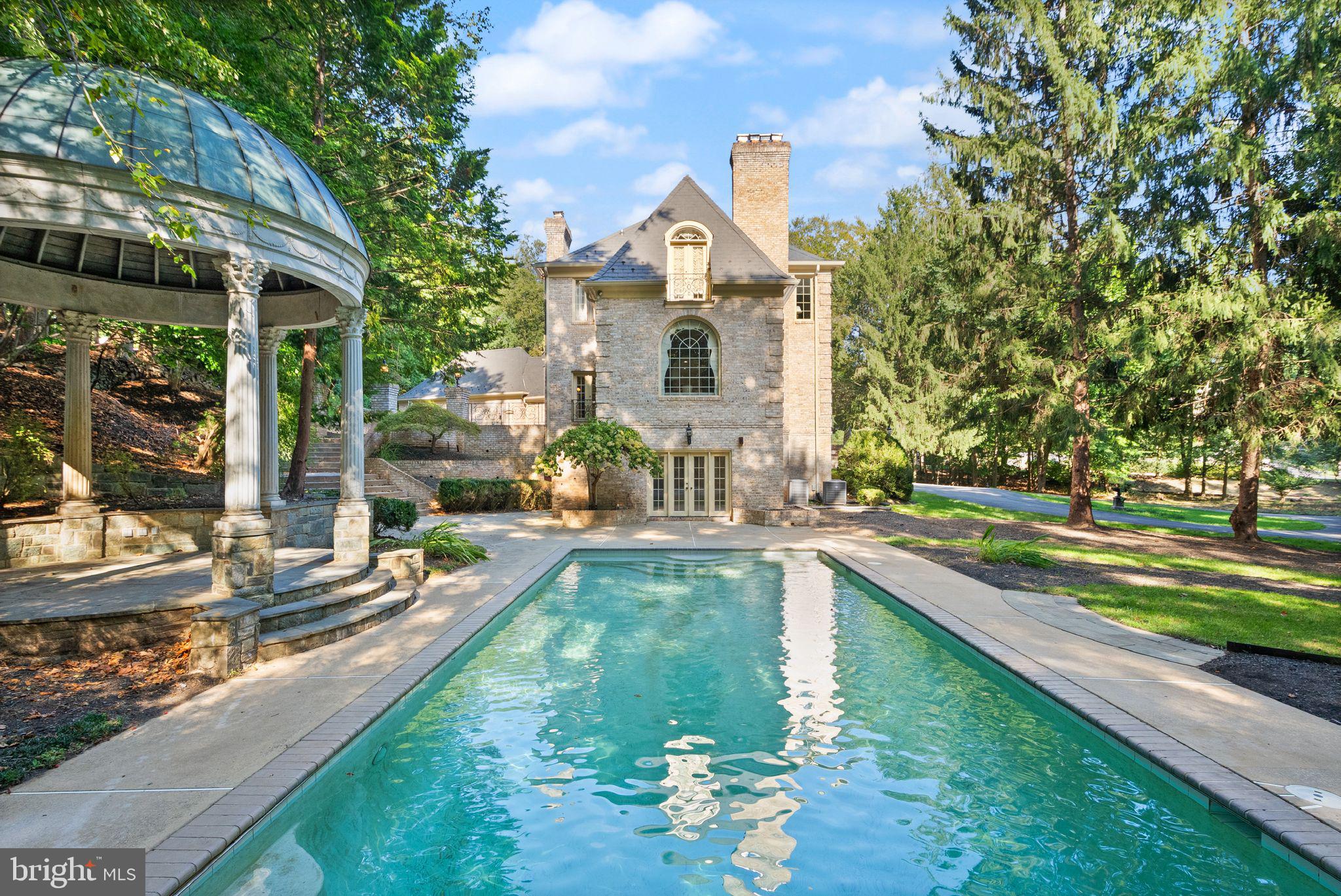 Welcome to 9721 Sorrel Avenue — A Landmark Potomac Estate Where Architectural Artistry Meets Exceptional Living

Designed by renowned architect John Leslie Neufeld, this extraordinary residence offers a rare opportunity to own a truly distinctive estate in one of Potomac’s most prestigious and private settings. Defined by dramatic architectural lines, sweeping curves, and grand proportions, the home delivers both impressive scale and warm livability.

From the moment you arrive, the property makes a lasting impression with a 100-year genuine slate roof, elegant circular driveway, and a separate private motor court, all set within beautifully landscaped grounds that create a sense of arrival and exclusivity.

Inside, expansive light-filled interiors showcase soaring ceilings, custom plaster moldings, rich hardwood floors, and intricate millwork. Designed for both grand entertaining and everyday comfort, the main level features gracious formal living and dining rooms alongside a stunning sun-drenched family room with walls of windows and an expansive skylight.

At the center of the home is the chef’s kitchen, thoughtfully designed with premium appliances, custom cabinetry, a generous island, and a convenient rear staircase connecting the living spaces seamlessly.

One of the home’s most remarkable highlights is the hand-carved walnut library, a true work of art that adds warmth, character, and architectural distinction rarely found today. The residence also offers exceptional lifestyle amenities, including a disco lounge, golf simulator room, and game room, creating unforgettable spaces for entertaining and recreation.

Upstairs, the luxurious primary suite serves as a private retreat with a sitting area, marble fireplace, spa-inspired bath, and dual walk-in closets. Each additional bedroom is generously sized with its own en-suite bath, providing comfort and privacy for family and guests.

The walk-out lower level offers flexible living space ideal for a home theater, fitness studio, guest quarters, or extended-stay accommodations. Outdoor living is equally impressive, featuring a copper-roof gazebo, fountain with classical statuary, expansive entertaining terrace, and manicured grounds surrounded by mature trees, creating a peaceful and private estate setting.

Ideally located near Potomac Village, top-rated schools, parks, and major commuter routes, this home combines architectural significance with everyday convenience.

9721 Sorrel Avenue is more than a residence — it is a statement of design, craftsmanship, and lifestyle rarely available in today’s market.
Experience a home that is truly unforgettable.