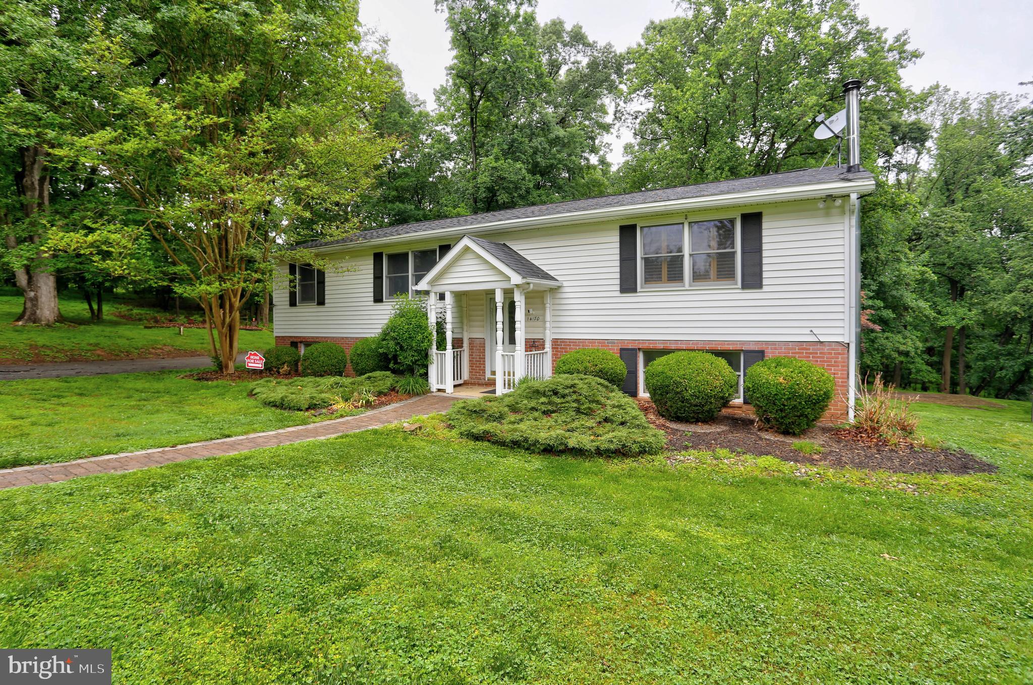 Welcome home to space, serenity, and endless potential. This secluded 5 acre retreat in Cooksville offers timeless charm, scenic views, and exceptional privacy—all within minutes of Rt. 70 and convenient access to Baltimore, Frederick, Washington, DC, parks, and local amenities. Lovingly maintained by its original owners, this 4 bedroom, 2.5 bath home features two full levels of living space. The upper level includes a bright living room, dining room, spacious eat in kitchen, three bedrooms—including a primary bedroom with a private half bath—and a full hall bath. A large deck extends your living space outdoors with peaceful views of the property. The lower level offers a generous family room with a wood stove, a fourth bedroom, a full bath, laundry area, utility room, and additional storage, plus a walkout to the expansive backyard. Outside, enjoy a detached one car garage with electricity, a shed, and ample driveway parking. Enjoy peace of mind with the included whole-house backup generator. The 5 acre lot provides wooded seclusion, open space for recreation or gardening, and backs to 55 acres of protected conservation land that will never be developed.  A rare opportunity to own a private retreat in Howard County—full of potential and ready for your personal touch.