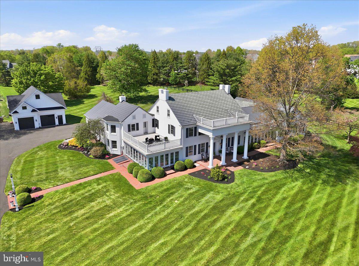RITTENHOUSE ESTATE - Since 1775 -  HISTORIC ELEGANCE MEETS MODERN LUXURY! 
Featuring Two Private and Modern Living Quarters! 
The Main House has 5 BR's - 3 Baths -  Addition w/ 2 BR -1.5 Baths.  In the rarest of occasions, a home is so breathtakingly exceptional in everyway that it evokes emotion in your heart. This is such a home. Historically significant and remarkably renovated by 11 generations. Set on the grounds of a 1775 hand-dug well, topped with tempered glass for viewing ancestral craftsmanship. This rare feature is surrounded by a peaceful courtyard w/magnificent planting.  The outdoor setting is a PRIVATE RETREAT with lush gardens, manicured boxwoods, glorious gazebo, and sparkling pond with fountain creating a serene resort-like setting.  Multiple oversized garages, including workshops, provide exceptional storage and functionality.  Inside, timeless craftsmanship meets high-end design.  A quartet of Williamsburg-inspired columns highlight the beauty of the expansive front porch and set the stage.  Inspired by the drama of hand-kerfed walls that match deep window sills found throughout the home, the  NARI  award-winning Chef's Kitchen by Harth Builders showcases abundant white custom soft-close maple cabinets glazed in a gray finish that harmonize with the center island w/mounted microwave, expansive quartz tops, and neighboring wet bar w/Sub-zero ice-maker. Signature red-knob Wolf  six-burner range with double ovens and grill, Sub-zero refrigeration, three pantries, and  premium appliances throughout. Natural light bathes the kitchen’s adjoining sunroom, a dining spot of pure perfection. Wrapped in windows, pleasure surrounds you inside and out you might never want to leave this gathering spot of the home.  Windows at every turn and curve take full advantage of stunning views and provide unlimited light throughout the home. In addition to the sunroom dining area there is an exceptionally large formal dining and living space in the center of the home - perfect for holiday dinners and social entertaining events. You can't help but notice the uniquely beautiful antique Long-Leaf pine 10' wide floorboards, the unusual 12"  baseboards, stunning chair rail and crown molding.  Stone walls are 24" thick.   All these features add to the property’s elegance and unique charm. A spacious family room next to the kitchen w/ gas fp provides warmth and comfort  and plenty of space for relaxing and gathering.  The first floor’s flexible floor plan also includes two additional rooms (ideal for bedroom, offices, or playroom), full bath and convenient laundry/mud room. The drama continues on the second floor. The owners’ suite includes a dressing room and en-suite bath   The beautiful large bay window in the owners’ BR floods light in the morning to start your day.  Enjoy scenic views and listen to the waterfront sounds of the pond fountain while sitting on the private porch of the BR.  Three other large bedrooms are accented with curved walls and deep comfortable window seats, yet one more way to take in the incredible views - every room has multiple windows for panoramic views! The walk-up third floor attic allows for plenty of  storage space. A major highlight is the mirror- image, 2 BR/1.5 bath 1450 SQ FT. ADDITION WITH PRIVATE ENTRANCE  which can opt for dual living, as inlaw suite, room for older children etc.  Features include a living/dining area, sunroom, full kitchen w/ island, quartz counters, two pantries, continuing longleaf pine wood floors, a laundry, expansive heated garage, and surprisingly copious storage throughout. The main BR and bath include the latest style bathtub, double sink, wainscoting, and threshold-free shower. As in the estate home, views are endless. Each step you take unveils an exquisite architectural touch, a piece of beautifully preserved history, and rooms filled with special and unique features. It's a home you simply must see - You  won' t want to leave!