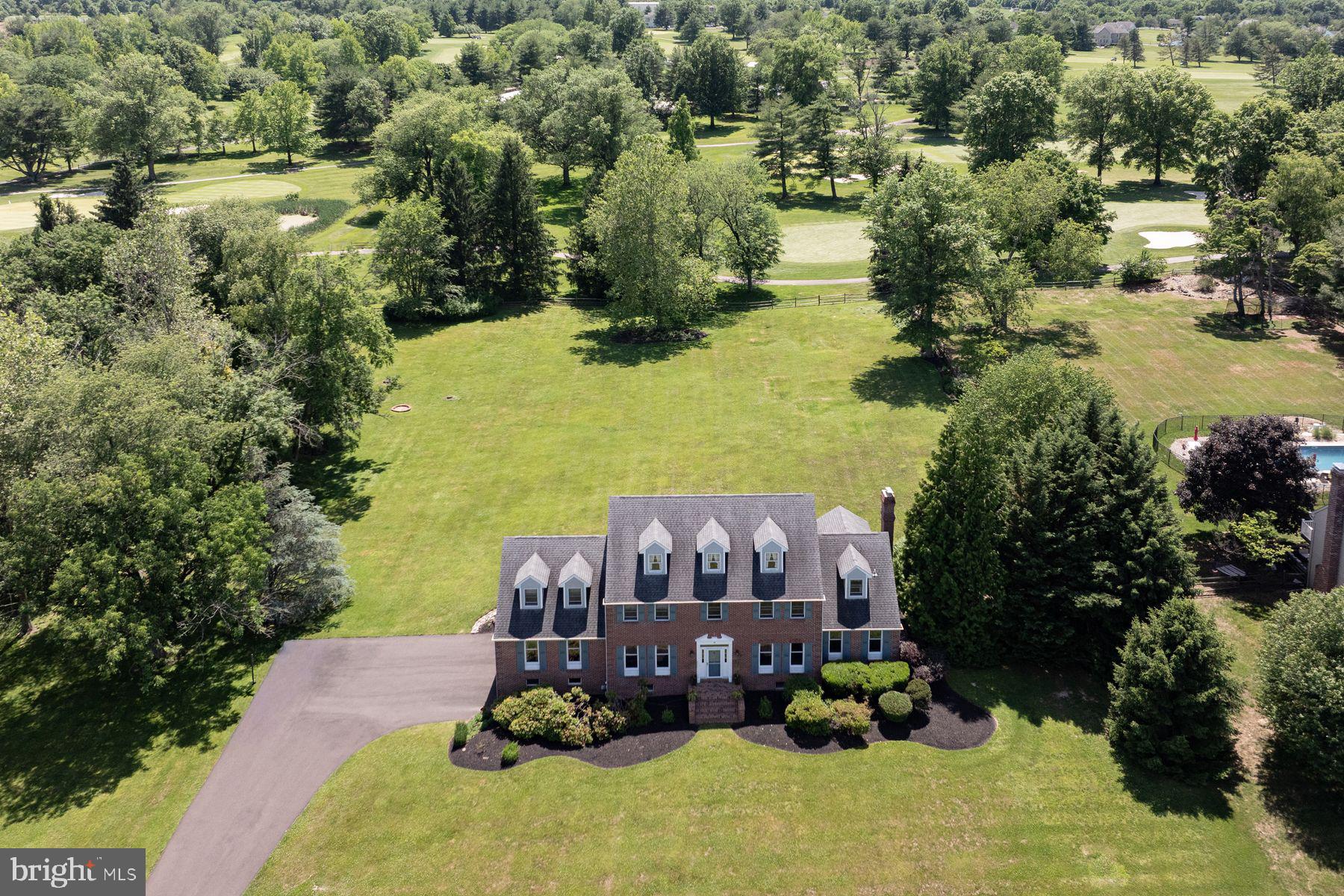 Welcome to 48 Bobbie Drive! Set on nearly two acres and backing directly to Spring Mill Country Club, this stately brick Colonial offers a rare combination of timeless architecture, generous living space, exceptional flexibility, and sweeping golf course views.

Step into the welcoming center hall foyer, flanked by a spacious formal living room on one side and an elegant formal dining room on the other.

At the heart of the home is a large eat-in kitchen featuring abundant cabinetry, a generous dining area with a bay window, and tranquil views of the backyard. The open floor plan flows seamlessly into the adjacent family room, highlighted by a handsome brick fireplace and French doors that open to a peaceful patio overlooking the expansive rear yard and long-distance golf course vistas.

Just off the family room, double doors lead to a private office or flex space, ideal for working from home, a playroom, library, or quiet retreat.

The main level also features a powder room, a convenient mudroom/laundry room with rear entrance access, and an impressive additional wing offering remarkable potential for multigenerational living, an in-law suite, guest quarters, or future customization to suit a variety of needs.

The upper level offers five bedrooms, including a spacious primary suite with two large walk-in closets and an ensuite bath featuring a double vanity, soaking tub, and separate shower.

Four additional generously sized bedrooms provide ample accommodations and are served by a hall bathroom with a double vanity and tub/shower combination. A walk-up third floor currently provides outstanding storage space but offers excellent potential to be finished into additional living space.

The large basement presents endless possibilities for future finishing, recreation, storage, or workshop use and provides direct access to the three-car garage.

The setting is what truly distinguishes this property. Backing directly to Spring Mill Country Club, the home enjoys a rare combination of privacy, openness, and scenic beauty. The deep backyard, panoramic golf course views, and peaceful surroundings create an exceptional outdoor environment that can be enjoyed throughout the seasons.

Located within the highly acclaimed Council Rock School District, consistently recognized among Pennsylvania's premier public school systems, this home also offers convenient access to shopping, dining, golf courses, parks, and major commuter routes. Nearby attractions include Tyler State Park, where miles of scenic trails, recreation, and natural beauty await.

Offering space, versatility, and an extraordinary setting, 48 Bobbie Drive presents a rare opportunity to enjoy a lifestyle defined by comfort, convenience, and enduring appeal.