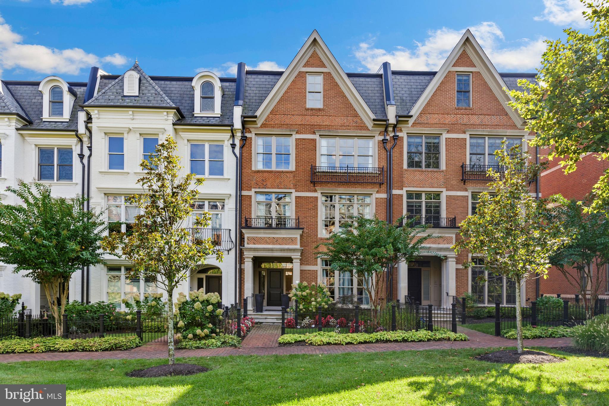 This Spectacular Light-Filled Elevator Townhome in Symphony Park has been tastefully designed and customized with luxurious fixtures and finishes throughout. The entry level features a beautiful curved staircase, stunning Travertine floors, a gracious office/library, an exercise room or bedroom with full bath, and a custom built-in mudroom. Moving to the main level you will see hardwood throughout, the gourmet kitchen has a huge marble island, white painted Brookhaven cabinetry to the ceiling. Top of the line appliances include a Viking stainless refrigerator plus several appliances including a Viking 6-burner gas range and hood, A Viking wall oven, and a Viking microwave & convection oven, along with a Viking dishwasher. The attached family room features coffered ceilings, a gas fireplace, plus a large custom tufted velvet banquette with a beautiful table designed for the space. Conveniently located off the family room is a balcony with a gas connection for outdoor grilling. The living room features custom architecturally designed brick wall, a furniture-quality entertainment wet bar that includes a beverage chiller along with a wine chiller. The primary bedroom suite features hickory hardwood floors with built-in walk-in closets and a large seating area with custom built-ins and fireplace. An exquisite marble mosaic tile accent wall in the primary bathroom is a stunning backdrop for the clawfoot soaking tub. Flooring and shower wall tiles are marble as well. The primary bathroom also features waterworks fixtures. The guest suite includes a large walk-in closet and bathroom with a large vanity and linen closet. On the upper level, there is a stunning entertainment space featuring a full wet bar and a double sided fire place leading out to an enormous outdoor rooftop terrace with fantastic views. The 4th bedroom is an en-suite w/ full bath. Symphony Park is integrated with the Music Center at Strathmore in a campus-like setting. Community features include cobblestone entry with elegant brick walkways and ornamental fountains at the Gateway to Strathmore, in addition to richly detailed European-style gardens and mews. It is a short walk from the townhomes to the Grosvenor Metro (Red Line) and just minutes from both I-495 and I-270 with convenient access to signature shopping, dining and entertainment attractions. Symphony Park is the perfect blend of urban and suburban!!!