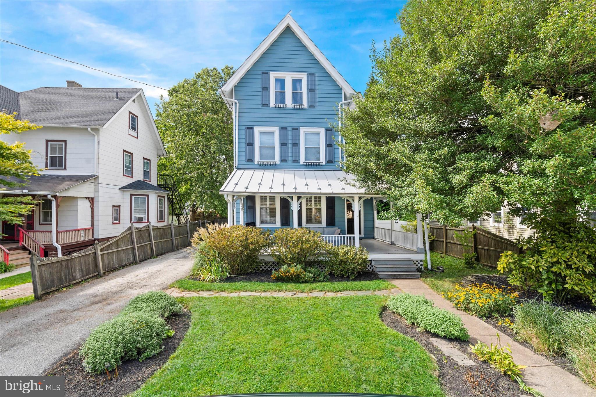Step back in time with this 1927 Traditional Victorian-style gem, located in the heart of beloved Bryn Mawr.  Boasting 4 generously sized bedrooms, 3 full bathrooms and a convenient powder room, this elegant, 3 leveled single-family home seamlessly blends historical charm with modern convenience. The rich character is reflected in the architecture's timeless details: a picturesque wrap-around front porch and a breathtaking foyer with an exquisite staircase. Hardwood floors flow throughout, enhancing the 9ft ceilings in the inviting family room complete with custom built-ins to the formal living room or office. Entertaining is a breeze in the formal dining room that opens up to a kitchen for the culinary enthusiast, showcasing custom cabinetry, sleek stainless steel appliances and premium granite counter tops. Unwind in your upper-level primary bedroom suite, featuring an updated bathroom complete with radiant floor heating, dual sinks, and a walk-in closet. Second bedroom and full bathroom complete this level.  The 3rd level includes two more bedrooms, along with a bonus room--perfect for an office, gym or playroom--and a full bathroom. Everybody gets comfortable with three independent zone heating and cooling systems, one on every floor. Outside, a spacious, fenced-in backyard with a beautiful bluestone patio awaits you, creating the perfect sanctuary for outside entertaining. Conveniently located just blocks away from regional rail, this home puts all the restaurants, shops, and parks Bryn Mawr has to offer just walking distance away. Don't miss your chance to call this treasured rarity this yours!