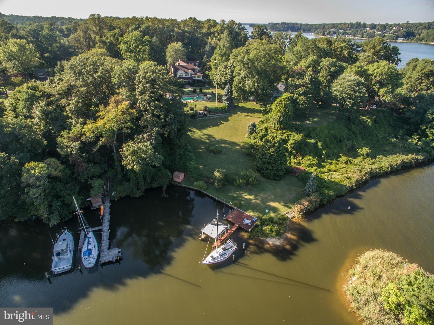 Late 19th century waterfront manor on over 1.5 acres of land on the Severn River. Architectural masterpiece with a spiral staircase leading to a 2nd floor billiards room overlooking the vaulted family room and kitchen. Character and unparalleled craftsmanship flow throughout this magnificent property that features a private pier, waterfront pool, 5 fireplaces, 7-car garage, and a guest house.