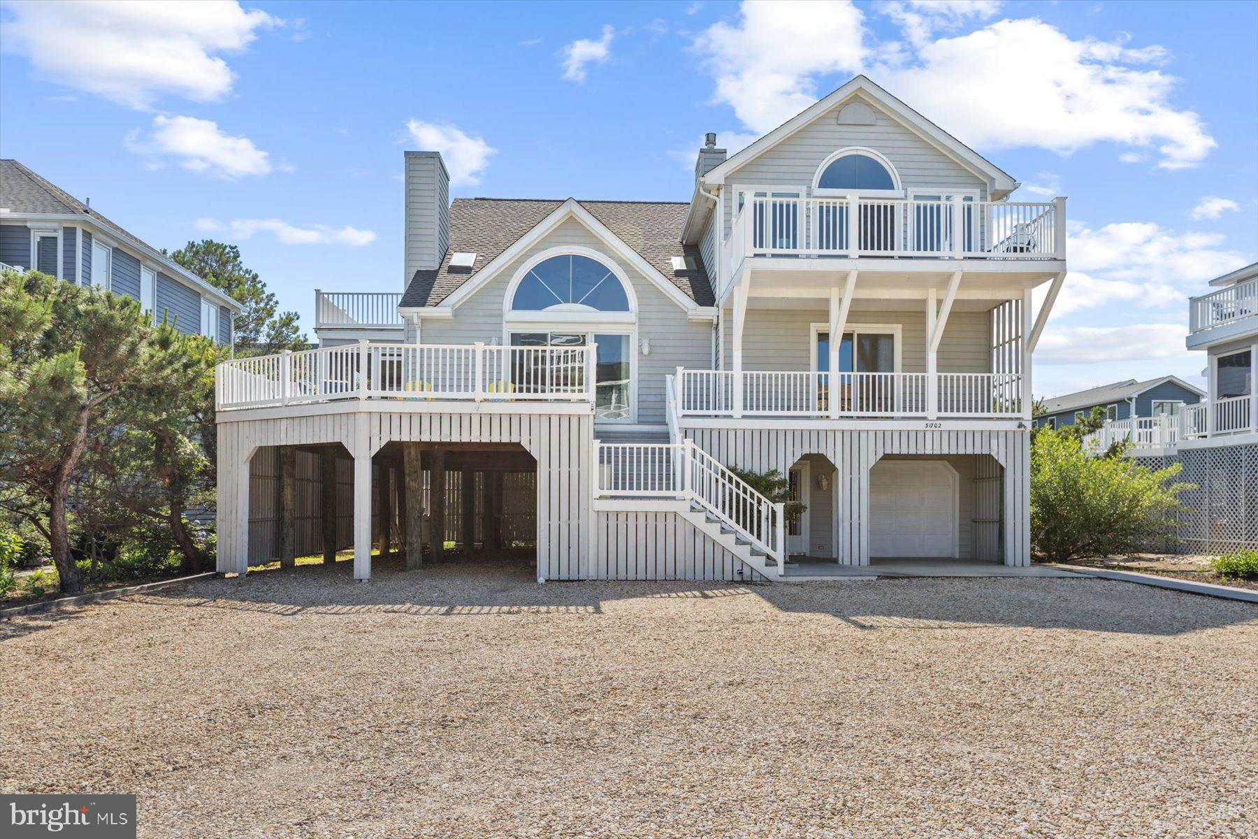 Meticulously maintained seaside retreat, just one home off the oceanfront in a prestigious North Bethany gated community with a lifeguarded private beach and tennis.  This charming coastal style home has an inverted floorplan, bringing the light-filled great room to the top floor to maximize views of the ocean while spending quality time with loved ones.  Enjoy the quiet morning sunrise while listening to the waves crash from one of two oceanside decks on this level.  Also on the top floor is a spacious primary bedroom with en-suite bathroom. A balcony on the west side of the home is conveniently located just off the kitchen for grilling.  One floor below, a second living room with beautiful wood ceilings and a fireplace opens to a delightful, screened porch and spacious deck.  You will find 3 additional bedrooms, two more full bathrooms, a powder room plus laundry on this level.  An over-sized garage with a second refrigerator and separate utility room on the ground level provide ample storage space for all your beach necessities and the outdoor shower and additional powder room on this level make coming and going from the beach a breeze! The current footprint of the home is able to be expanded or this spacious lot can easily support a sizeable newly-built home,  the possibilities are endless! Seabreak is highly sought after for its wide pristine beach and close proximity to downtown Bethany’s shops and restaurants.