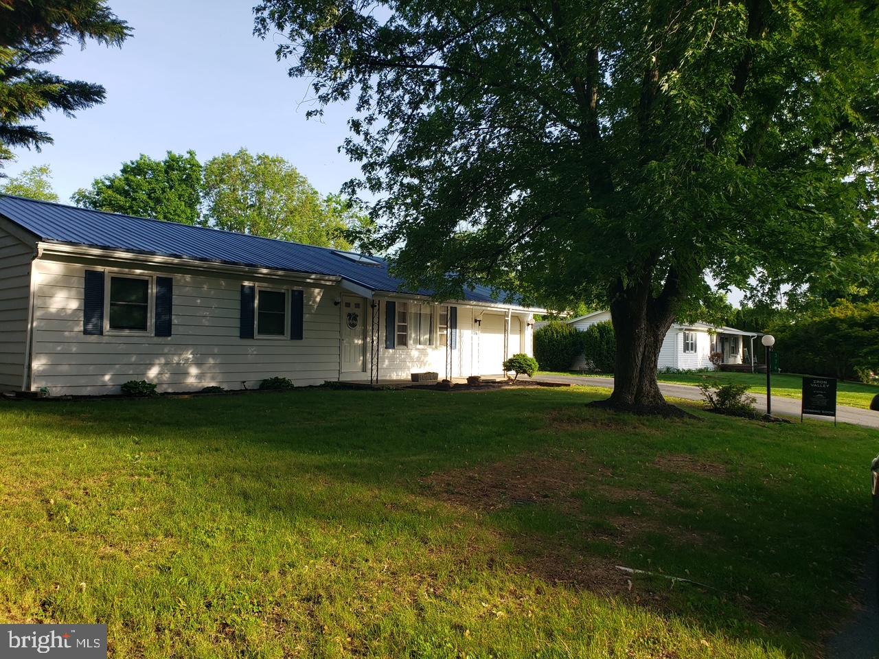 Well maintained 3/4 bedroom ranch home with a one car attached garage offering a spacious one-level layout with additional finished basement space. The home features two full bathrooms, a large living room with skylights and a comfortable seating area located just off the kitchen. The kitchen includes newer appliances and updated countertops.
The main bedroom features floor-to-ceiling windows overlooking the backyard and pool area, bringing in plenty of natural light. A large finished room with a closet, in the basement, provides flexible additional living space that could function as a fourth bedroom, recreation room, home office, or guest area.
Some of the updates include a metal roof, newer heat pump with central A/C, and a 6-foot vinyl privacy fence enclosing the backyard. The in-ground pool requires repairs and a new liner. Any pool photos shown are virtual renderings intended to demonstrate the pool’s potential. Property is sold As-Is.
This property offers warmth, a country setting, and the convenience of being close to shopping. Must see!