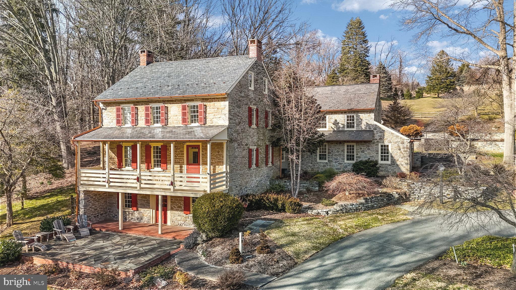Welcome to this magnificent sanctuary nestled in the historic township of Conestoga in Lancaster County, where the rich tapestry of history intertwines with modern luxury across 36 expansive acres. This charming 1900s farmhouse, originally built in 1845 with an addition in 1992, has undergone meticulous renovations and care (All major systems have been upgraded, see list of renovations). Spanning an impressive 4,600 square feet, this residence boasts five bedrooms, four full baths, and one half bath, providing ample space for both formal gatherings and casual living. As you step inside, you're greeted by the perfect blend of old-world elegance and contemporary comforts with hardwood floors adorning each room and several fireplaces filling the atmosphere with warmth and character. At the heart of the home lies a well-appointed kitchen, with a charming breakfast area, featuring a wall of windows and skylights allowing natural light to fill the space. The open kitchen has a grand fireplace with a custom original barnwood mantle, a subzero refrigerator and a large central island designed for culinary creativity. A butler's pantry, complete with plenty of storage and prep space, ensures seamless entertaining for every occasion. Outside, the allure continues with multiple porches and patios beckoning you to unwind and soak in the panoramic views of the lush countryside. A heated in-ground concrete pool, accompanied by a hot tub, offers a serene oasis for relaxation and leisure, while the surrounding patio serves as an idyllic setting for outdoor dining and entertaining.  For those with equestrian or farming aspirations, there is a spacious two level bank barn with electricity, water access, ample storage and parking options, complemented by an additional tobacco barn for added purpose and convenience. Both structures boast new roofs, ensuring longevity and functionality for years to come. Conservation efforts have been paramount in restoring this natural paradise, fostering an environment of flourishing wildlife and meadows full of colorful flowers. This serene escape offers privacy and tranquility while remaining within close proximity to shopping, schools, and healthcare. With its inherent charm and timeless character, this estate presents a rare opportunity to own a piece of Lancaster County's storied past. Enjoy country living while creating cherished memories for generations to come. Don't let this chance slip away, schedule your tour today!