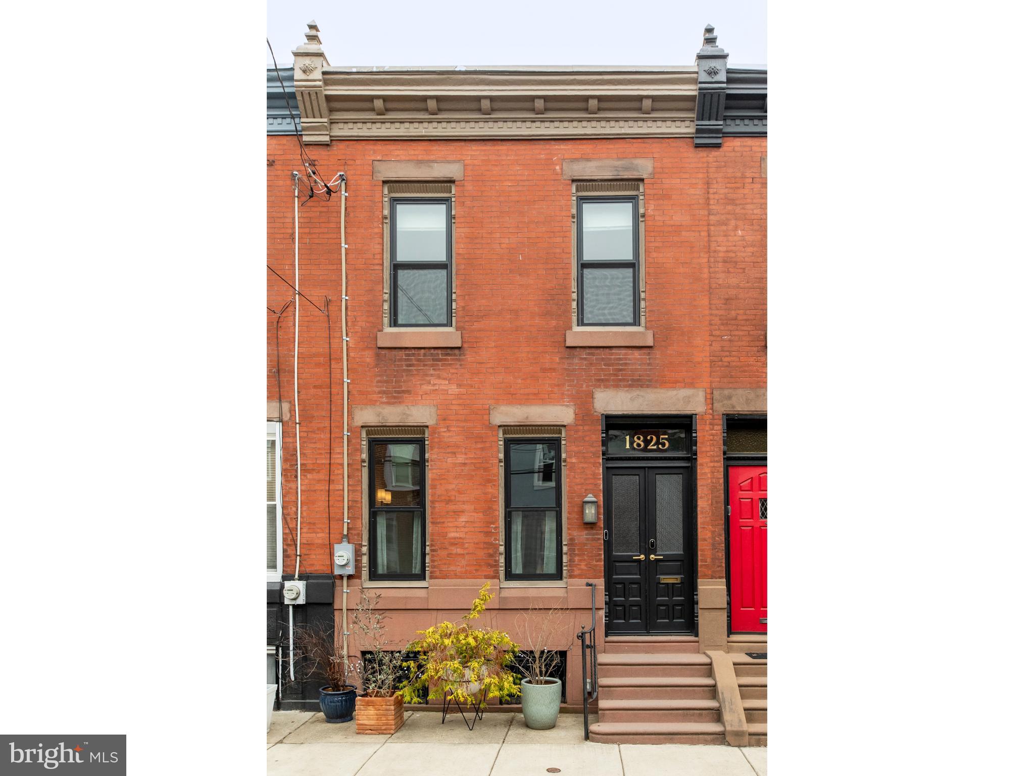 Located on one of the prettiest blocks in Newbold, just 3 1/2 blocks from Passyunk Avenue, this meticulously restored and updated circa 1890s home is a gem in South Philadelphia. Built between 1887 and 1995, the home features the original refinished floors and staircase, the original slate fireplace surround in the living room, and several original doors and trim work throughout the house. Reclaimed and restored architectural items are infused throughout the house including the double front doors and some of the lighting fixtures. As you approach the home you will recognize the original character of the facade and the quality Marvin windows that were installed in 2021. Entering through the front doors you will land in a lovely foyer featuring a tiled floor, multi-light interior door, and slate wainscotting. The foyer leads to an open living area anchored by the fireplace mantel, the elegant staircase, and the oak flooring with walnut bordering. Plentiful natural light enters the space through the west-facing windows. The living area connects to the kitchen/dining room through a wide archway, creating both spaciousness and separation. The dining area is large enough for gatherings of family and friends and is flanked by a coat closet and the entrance to the basement. The recently updated kitchen (2021) features a long peninsula with seating for four, white Shaker-style cabinets with brass hardware, quartz countertops, a beautifully tiled backsplash, and a range hood that exhausts to the outside. Beyond the kitchen is an addition featuring a pantry wall, a laundry area with countertop and storage cabinets, and a very well-placed and well-designed powder room. The rear door opens to a nice patio lined with permeable pavers and has room for grilling and lounging. The second floor features a wonderful primary bedroom room featuring an east-facing bay window, a wall of custom-built clothing cabinetry, an original corbeled arch, fine original moldings, and one of several restored radiators placed throughout the house. The adjacent full bath offers a beautifully tiled shower stall complete with a deep soaking tub. The sink has a side counter and cabinet offering plenty of storage for cosmetics and grooming products. The two additional bedrooms on the floor are of good size, with good storage, and each offers unique architectural and design elements. Behind all the beautiful features, the home was rewired with 200 amp service in 2021, and in the same year, a high-velocity air condition system was installed. Historic features with modern updates, this house has it all while being just a few blocks from South Philly favorites like the original Ultimo, 2nd District, The South Philly Tap Room, Hardena, Los Cuatro Soles, Gabriella's Vietnam and so much more. This is a house that you don't want to miss.