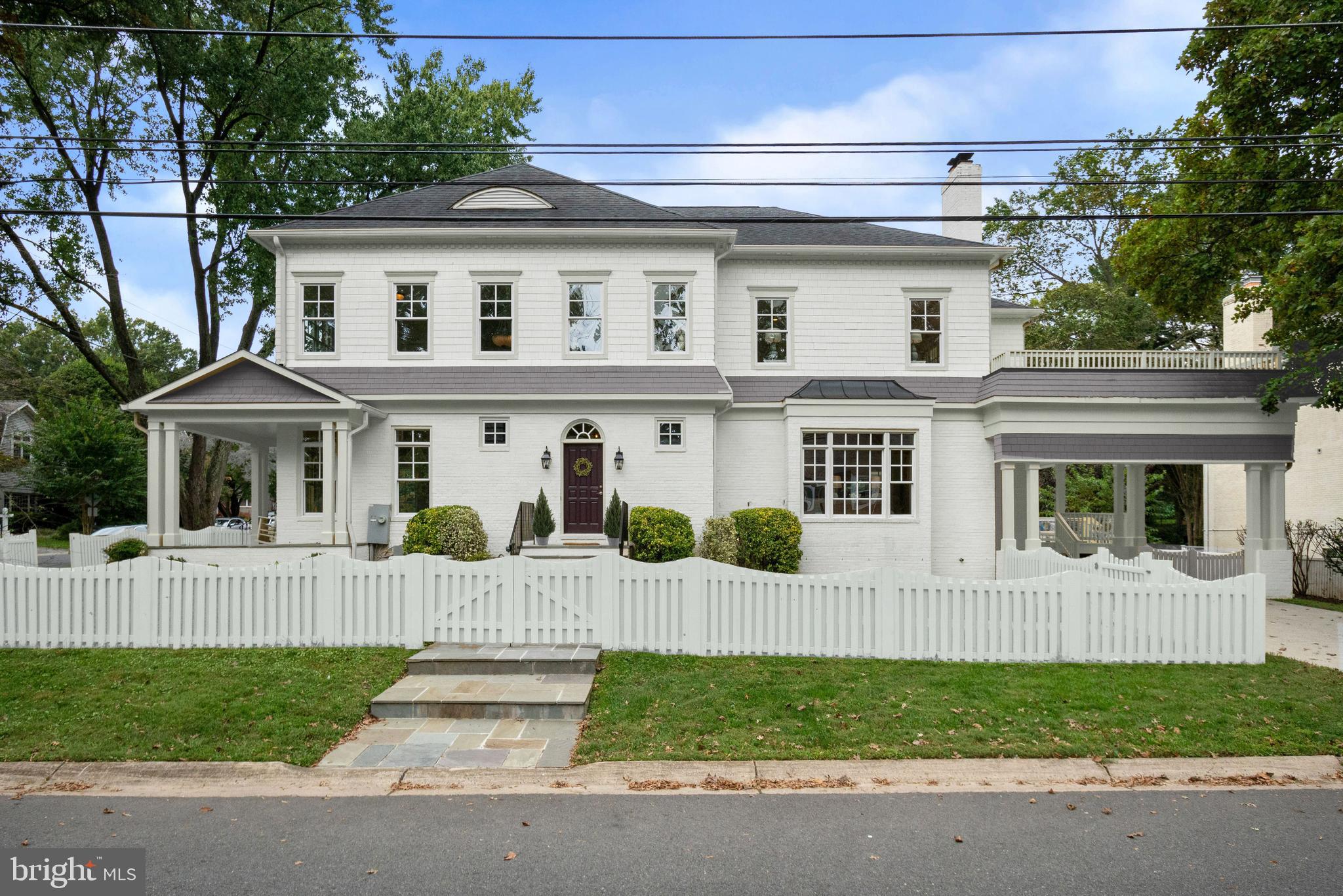 EXTERIOR PHOTOS SHOW ALTERNATE HOME COLOR. Here it is! The hard to find house with the amazing location inside the beltway that doesn't sacrifice square footage or modern finishes. Stunning, light-filled porch front home in the heart of the Village of North Chevy Chase  w/proximity to downtown Bethesda, downtown DC, and other points while boasting approx 6,300 beautifully finished square feet. Designed & completed by Artery Custom Homes in 2004, this spectacular porch front residence on a sizable corner lot blends in seamlessly with the older Chevy Chase homes of the neighborhood and offers the features, spaces, details and finishes that today's buyers expect. Updates are everywhere including newly refinished hardwood floors, brand new stain-resistant carpet in bedrooms and basement, and fresh paint! The front door opens to an impressive and spacious foyer and gallery hall that extends through to the family room. Attention to detail in the home is noteworthy and seen in the 10' and coffered ceilings, ample oversized windows, three-piece molding and custom trim, and more. The main level includes a spacious living room with fireplace, large dining room, open and airy gourmet cook's kitchen with walk-in pantry, a breakfast room open to a beautiful family room with fireplace and stunning coffered ceiling, and a separate office with floor-to-ceiling windows. Doors from the breakfast room lead to rear deck and yard, and access to the covered carport for two. Additional entry from the side yard also leads to the gallery hall, powder room and coat closet. The upper level features 9' ceilings and four bedrooms, three full baths, plus an additional sitting room and a laundry room. The owner's suite includes an oversized sumptuous spa bath with dual showers, linen closet, walk-in closet, and opens to a spacious and private outside terrace! Two bedrooms share a Jack and Jill bath, and the third has its own bath en-suite. The sitting room off the owner bedrm is ideal for use as an office or nursery or could easily be converted to a fifth upper level bedroom. A recreation room with fireplace and wet bar, media room, two additional bedrooms (one currently used as the gym) and a full bath are found in the fabulous lower level with walkout access and 9' ceilings. The fenced yard features a rear deck with partial cover, and an attractive, landscaped and level yard. There is also a state of the art Generac generator, which will power 80% of the home as needed. Residents of North Chevy Chase know what a great location they have, as access to shopping, transportation and parks is hard to beat, and now is the perfect time to join this sought after community.  Plans for the nearby Chevy Chase Lake development, slated for completion in Fall of 2021, include retail anchored by a grocery, Ritz Carlton condos, direct access to the new Purple Line, and more. In the meantime, residents continue to enjoy the grounds of the Audubon Society, Candy Cane City, Rock Creek Park, and Meadowbrook Stables. A major bonus (and for many, the social epicenter of the neighborhood) is the fabulous North Chevy Chase Swimming Pool Association, only two blocks away. Membership to residents of North Chevy Chase is available by application and offers three pools, swim and diving teams, plus year-round tennis, social activities, community events, and more. North Chevy Chase Elementary School is also within two blocks! Nearby as well are Starbucks, Einstein Bagels, banking, gas stations, a beloved neighborhood veterinarian, and more. Often thought of as one of the best-kept secrets in our area, the neighborhood of North Chevy Chase is one of those rare, tight-knit and extremely welcoming communities where neighbors routinely gather for Halloween, 4th of July, summer-end pool parties, community yard sales, Thanksgiving food drives, and more. Homes here aren't often on the market as many residents simply cannot bear to leave this gem of a neighborhood. Don't miss your chance!
