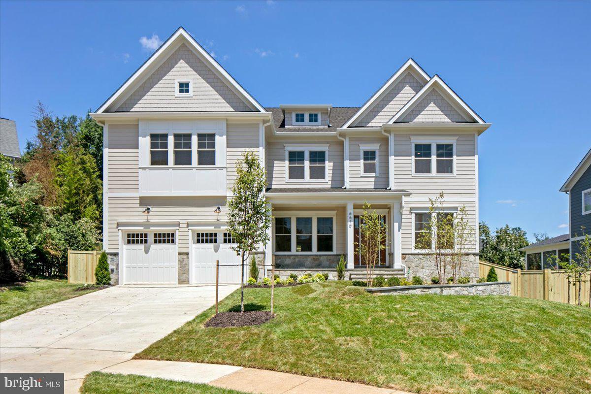 Just comleted! Introducing 6610 Quinten Street — a new custom-built 7BR/6.5BA modern craftsman by McLean-based Focal Point Homes, tucked onto one of Falls Church's quiet cul-de-sacs. This well thought out floor plan features a two-tone chef's kitchen pairing Willow perimeter and Verde island cabinetry beneath Calacatta Antique quartz countertops, a custom wood hood, and a full Sub-Zero, Wolf & Cove appliance suite. Open main-level living is anchored by 10' ceilings, 4" white oak floors, Andersen wood windows, warm brass lighting, and a marble-look porcelain fireplace surround. The owner's suite indulges with a freestanding soaking tub, rain shower, and dual lit vanities, while a finished lower level adds a bedroom, full bath, and dedicated fitness room. Outside, a covered flagstone porch overlooks the fully fenced, private backyard — all within walking distance of Haycock Elementary and Longfellow Middle, in the coveted McLean HS pyramid.