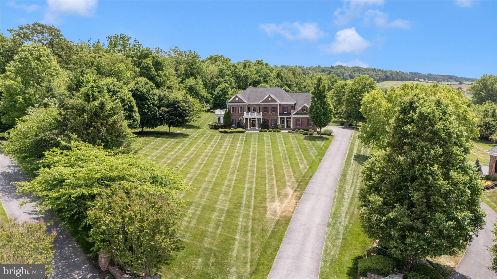 Tucked away at the end of a quiet cul-de-sac within the prestigious Vistas at Springdale of Middletown, stands an exquisite property that embodies the pinnacle of luxury living and relaxed elegance.  Spanning an impressive 5,366 square feet, this home is a harmonious blend of grandeur and functionality, designed for those who appreciate the finer things in life.  Step inside to discover a grand foyer that sets the tone for the entire home, featuring rich Brazilian Cherry floors that flow seamlessly throughout the formal living and dining rooms on either side of the foyer.  As you walk from the foyer straight to the two story family room you’ll be inspired by an expansive wall of windows, floor to ceiling that is the centerpiece of the home.  The views of the grounds are beautiful any time of year, bright and airy in the summer, and warm and welcoming in the winter with a gas fireplace to enjoy. The family room is open and flanks a wide hallway also with Brazilian Cherry. Beside the family room is the expansive kitchen, with granite countertops and beautiful cabinetry, an island, gathering area for the table, another fireplace, and an entrance that leads to the patio.  As you walk the hall that flanks the open family room you pass a home office with sophisticated built-ins and beyond that is the sunroom, which also leads you back to the living room.  As you enter the living room back to the grand foyer you’ll access the staircase to the upper level which features four bedrooms, each with walk-in closets.  The primary suite is truly a private retreat, with an entryway accessing a coffee bar leading into a sitting area, with a lovely balcony on one side and the primary bedroom on the other side. The private bath is adorned with luxury finishes, a large jetted tub, separate shower and separate vanities.  It also accesses walk-in closet number two, through another additional finished space, not present in other homes in the community, and provides a wonderful location for a yoga, meditation or craft room.  The second bedroom has a private entry suite backstairs of the kitchen and bedroom three and four, each have access to the huge rooftop balcony.  The upper-level laundry room adds convenience to daily life. The massive basement, with rough-ins for a bath and wet bar, along with the wide walk-up stairwell, is an open canvas for your vision.  Situated in the back of the community on 3.19 lush acres, it will be quick to slip into relaxation mode, enjoying the sounds of nature or warm get-togethers where everyone feels at home.  Experience refined living in a neighborhood and community that is truly desirable.