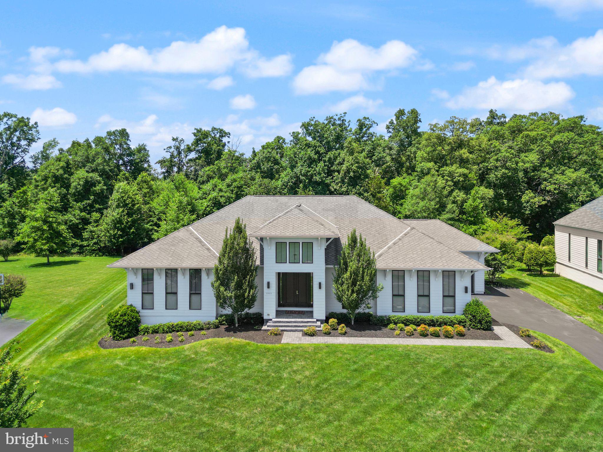 Experience European-inspired luxury in this exceptional 5-bedroom LINE K by Piet Boon residence in The Grant at Willowsford. Showcasing world-renowned contemporary design, this home features soaring 12-foot main-level ceilings and a spectacular rear wall of oversized windows that floods the living spaces with natural light while framing serene outdoor views. Wide-plank flooring, designer lighting, custom millwork, and a striking contemporary fireplace create a sophisticated yet inviting atmosphere. The chef's kitchen is beautifully appointed with premium Viking appliances, an oversized waterfall island, full-height stone backsplash, and expansive pantry storage.

Enhanced with over $180,000 in premium upgrades, this home is as functional as it is luxurious. The fully finished lower level offers four exceptional spaces, including a private in-law suite, a second home office, a fitness room, and a dedicated home theater with two-row stadium seating, a built-in AV rack, and pre-wiring for a projector and an immersive 6.3.4 Dolby Atmos surround sound system. The luxurious owner's retreat features motorized, remote-controlled shades and a spa-inspired bath. Smart home technology includes app-controlled Bose whole-home audio in the great room, patio, owner's bath, and gym, a Ubiquiti WiFi system, and Lutron smart lighting throughout. Outside, enjoy a professionally installed 10-zone irrigation system and seamless indoor-outdoor living. A rare opportunity to own one of Willowsford's most architecturally distinctive, technology-forward luxury homes.

This home sits in the award-winning Willowsford Community, surrounded by Loudoun’s wine country. Enjoy resort-style amenities—beach-entry pools, splash pad, lodge, fitness center, dog parks, sledding hill, tree house, and even a farm stand/CSA. Minutes from Brambleton and One Loudoun for dining, shopping, and entertainment, plus nearby Hanson Regional Park (257 acres!), farmers markets, Wegmans, wineries, and breweries. Convenient to Dulles Airport, Silver Line Metro, Tysons/DC, and top-rated Loudoun County schools.

*Schools are being rezoned for the 2026-2027 school year 
MS; Watson Mountain 
ES: Elaine Thompson