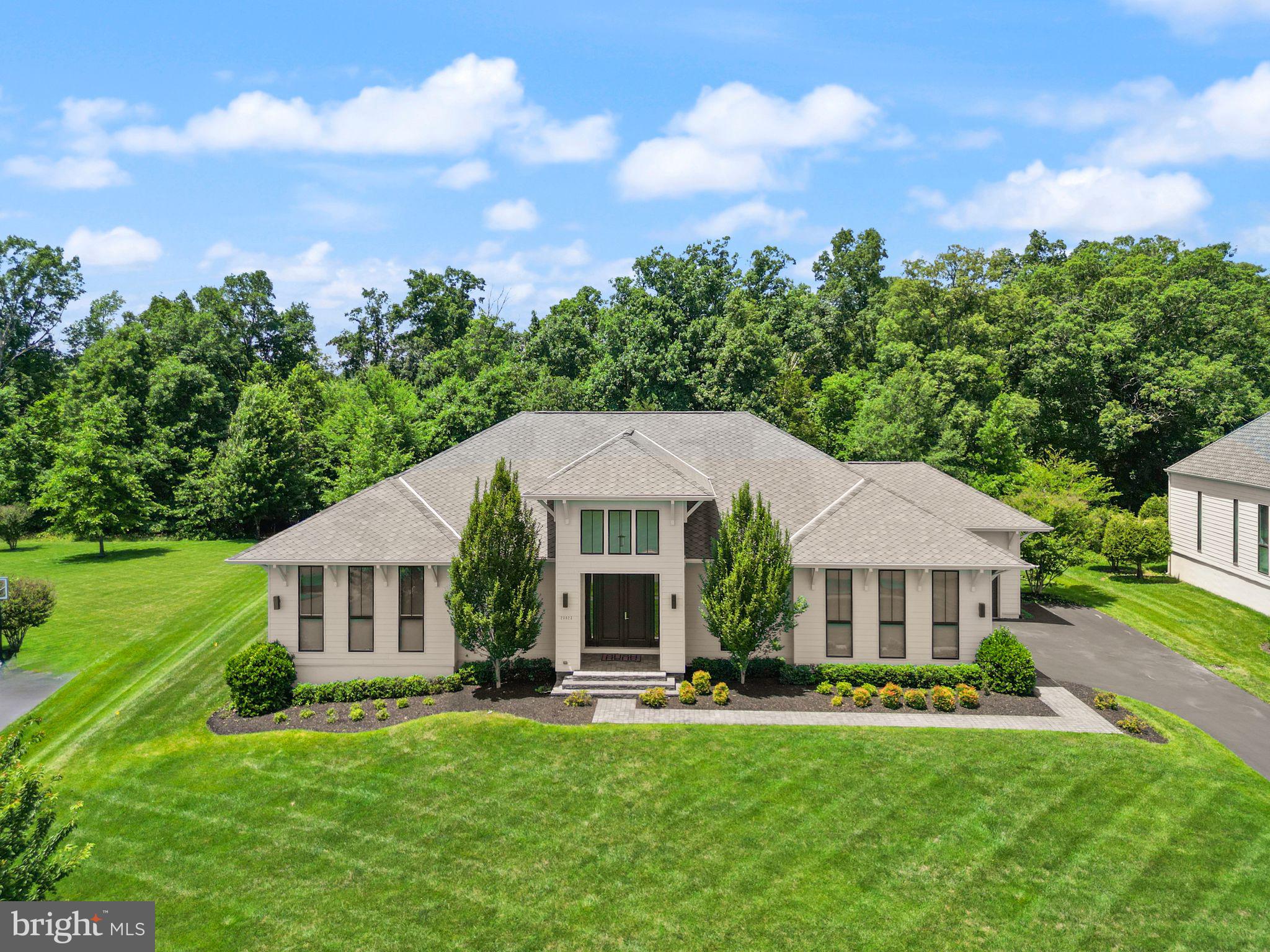 Experience European-inspired luxury in this exceptional 5-bedroom LINE K by Piet Boon residence in The Grant at Willowsford. Showcasing world-renowned contemporary design, this home features soaring 12-foot main-level ceilings and a spectacular rear wall of oversized windows that floods the living spaces with natural light while framing serene outdoor views. Wide-plank flooring, designer lighting, custom millwork, and a striking contemporary fireplace create a sophisticated yet inviting atmosphere. The chef's kitchen is beautifully appointed with premium Viking appliances, an oversized waterfall island, full-height stone backsplash, and expansive pantry storage.

Enhanced with over $180,000 in premium upgrades, this home is as functional as it is luxurious. The fully finished lower level offers four exceptional spaces, including a private in-law suite, a second home office, a fitness room, and a dedicated home theater with two-row stadium seating, a built-in AV rack, and pre-wiring for a projector and an immersive 6.3.4 Dolby Atmos surround sound system. The luxurious owner's retreat features motorized, remote-controlled shades and a spa-inspired bath. Smart home technology includes app-controlled Bose whole-home audio in the great room, patio, owner's bath, and gym, a Ubiquiti WiFi system, and Lutron smart lighting throughout. Outside, enjoy a professionally installed 10-zone irrigation system and seamless indoor-outdoor living. A rare opportunity to own one of Willowsford's most architecturally distinctive, technology-forward luxury homes.

This home sits in the award-winning Willowsford Community, surrounded by Loudoun’s wine country. Enjoy resort-style amenities—beach-entry pools, splash pad, lodge, fitness center, dog parks, sledding hill, tree house, and even a farm stand/CSA. Minutes from Brambleton and One Loudoun for dining, shopping, and entertainment, plus nearby Hanson Regional Park (257 acres!), farmers markets, Wegmans, wineries, and breweries. Convenient to Dulles Airport, Silver Line Metro, Tysons/DC, and top-rated Loudoun County schools.

*Schools are being rezoned for the 2026-2027 school year 
MS; Watson Mountain 
ES: Elaine Thompson
