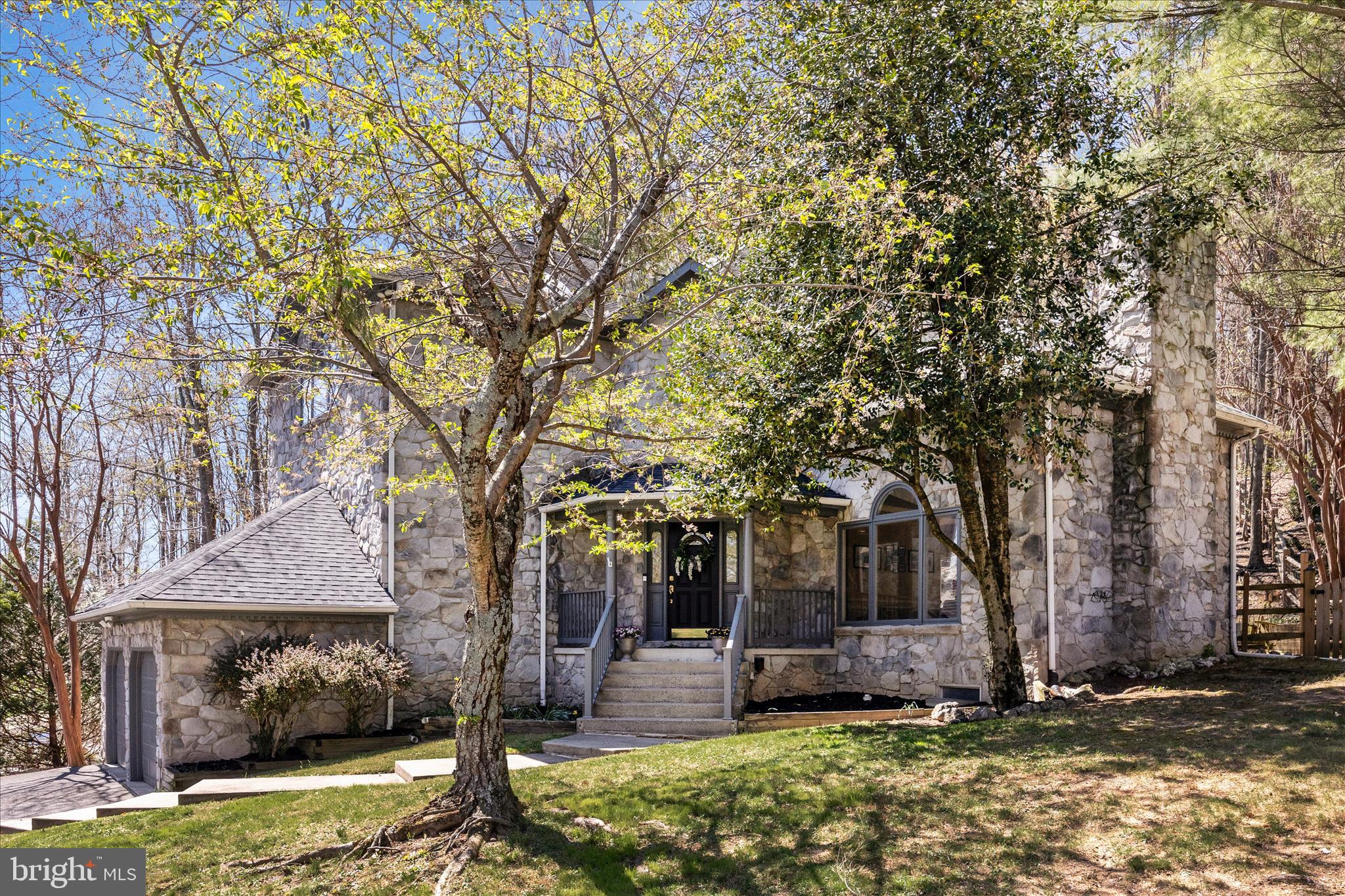 ***FABULOUS CUSTOM HOME***MUST SEE***WELCOME TO THIS ABSOLUTELY STUNNING ALL STONE HOME IN THE SOUGHT-AFTER ASPEN VILLAGE OF LOVELY AMENITY RICH LAKE LINGANORE***WITH ALMOST 4000 SQUARE FEET ACROSS 3 FULLY FINISHED UPGRADED LEVELS, THIS AMAZING 4 BEDROOM & 4 BATH HOME SHOWCASES EXCEPTIONAL CRAFTMANSHIP WITH SOARING CEILINGS AT THE FOYER, TRAY CEILINGS, CUSTOM TRIMWORK THROUGH OUT, SHIP LAP,  PELLA CASEMENT WINDOWS,  RECESSED LIGHTING,  A LARGE MAIN LEVEL BEDROOM, A GREAT ROOM, SOLID WOOD FLOORING & STAIRCASE & SO MUCH MORE***THE GOURMET KITCHEN & FORMAL DINING ROOM CREATE THE PERFECT SETTING FOR ENTERTAINING WITH A LARGE CUSTOM ISLAND WITH SEATING, STAINLESS STEEL APPLIANCES, MAPLE CABINETRY & A GREAT AMOUNT OF LIGHTING ALONG WITH BOTH A STONE WOOD BURNING FIREPLACE & A SLEEK ELECTRIC FIREPLACE THAT ADD WARMTH & CHARACTER***THE OWNERS SUITE ENJOYS A TRAY CEILING, CUSTOM MOLDINGS & TRIM, SOLID WOOD FLOORING & A FULLY RENOVATED LUXURY BATH WITH A LARGE ENCLOSED SHOWER WITH TWO SHOWER HEADS INCLUDING A RAIN SHOWER HEAD, CUSTOM TILE, NEW FIXTURES & A MAKE UP VANITY***FULLY FINISHED BASEMENT WITH LVT STAIRS & FLOORING, AN EXERCISE ROOM WITH GYM FLOORING, REMODELED FULL BATH & LOTS OF RECESSED LIGHTING***THE PRIVATE YARD INCLUDES A DECK & BRICK PATIO, A HOT TUB &TRAILS TO THE LAKE AND DAM***BRAND NEW 16.6 SEER 5 TON HVAC SYSTEM***CINCH HOME WARRANTY***COME & ENJOY THE LAKE LIFESTYLE***LOVE WHERE YOU LIVE***