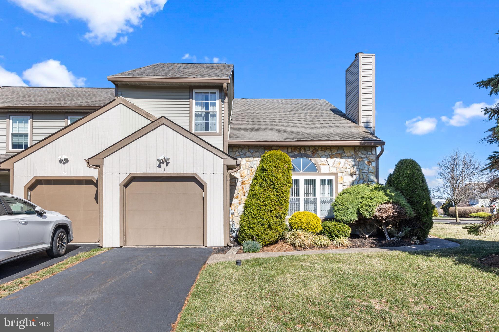 Amazing opportunity to build equity into a home in Newtown Township, Bucks County, PA! This 2 bedroom, 2.5 bathroom end of row townhome located in Newtown Grant and Council Rock School District is a diamond in the rough. This home just needs your loving touch and modern day design ideas to bring it up to speed. Situated on a premium corner lot on the outskirts of the Whispering Wood cluster, you will have easy access in and out of the development. Handsomely landscaped, there is an open space side yard, as well as a smaller fenced yard area to use for your outdoor enjoyment. Walking into the home, you will be delighted with the openess of the entry way leading into the large living room, with tons of natural light, 2 story ceilings and a wood burning fireplace. Beautiful hardwoods flow from the living area to the extra wide dining room with a bright bay window. The eat-in kitchen has a pantry closet, a nice amount of counter space for prepping food, gas cooking and a garden window which is the perfect place to showcase plants, grow herbs or simply add sunlight. Sliders from the kitchen lead out to the rear fenced yard with patio. The main floor laundry room is right off the kitchen, which also provides access to the one car garage. Finishing off the first floor, there is a powder room in the hallway and a coat closet with storage under the stairs. Upstairs, double doors open up to the super-sized owner's bedroom with ceiling fan and two closets, one being a 5' x 5' walk-in closet. The en suite bathroom has both a stall shower and a soaking tub. The vanity area is large enough to replace with double sinks. There is another spacious bedroom on the second level with two closets and direct access to the hall bathroom with tub shower. Original neutral colored hardwood flooring is located throughout the upper level bedrooms and hallway. Enjoy all of the amenities that the association has to offer with community events, pool, ball field, playground, tennis and basketball courts.