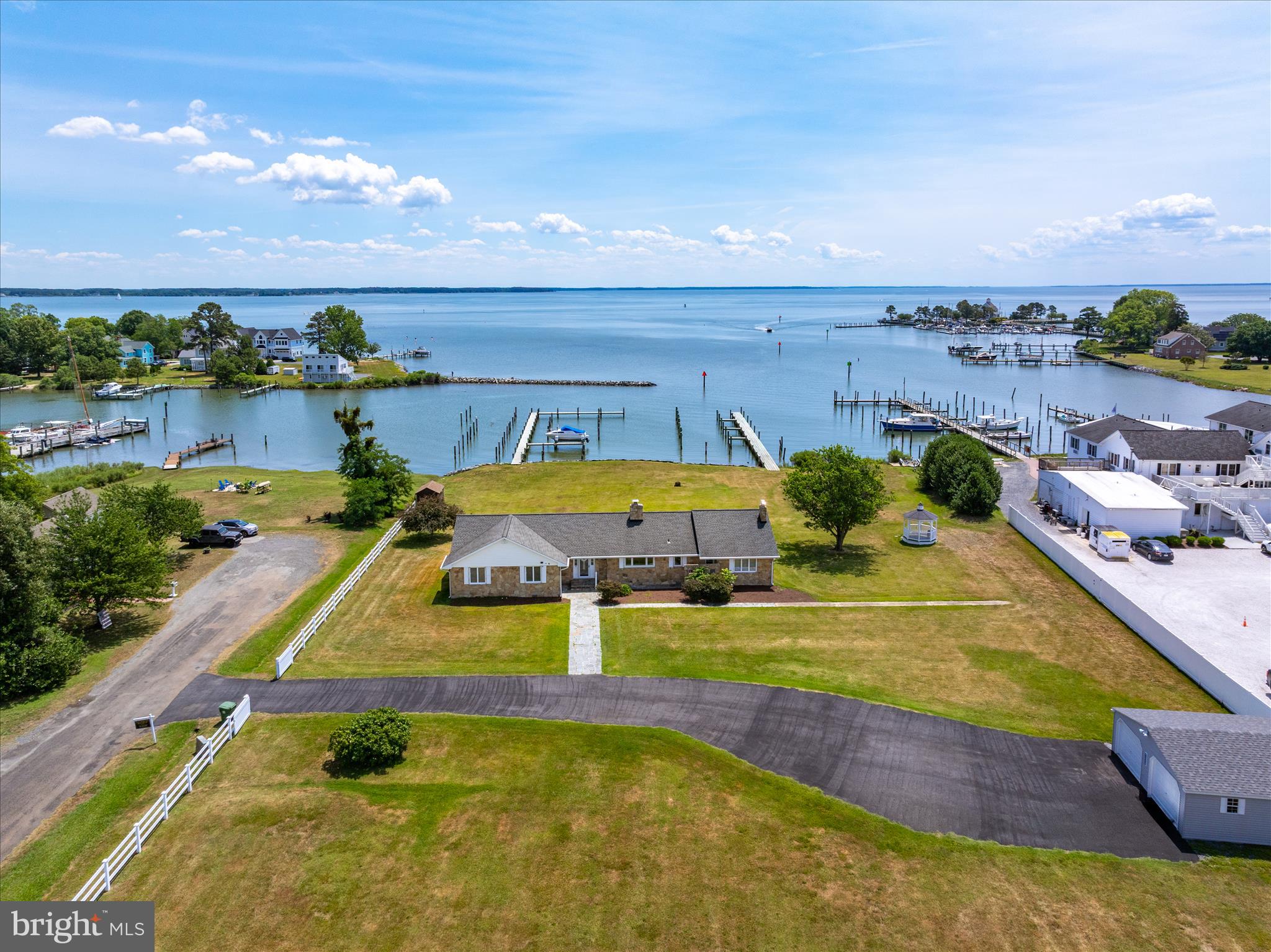 Unique Tilghman Island Property. Zoned Residential-Commercial. Situated on a 2.74 acre fenced yard. This 2450 sq ft Stone Rancher has many upgrades, new 2 car garage and 24 new commercial slips.  The possibilities are endless....... Vacation Rental, 24 brand new slips, typically rent from 175.00-225.00 monthly. Develop a new fishing center, crabbing tours, sunsets cruises. Let's see what you can dream up??