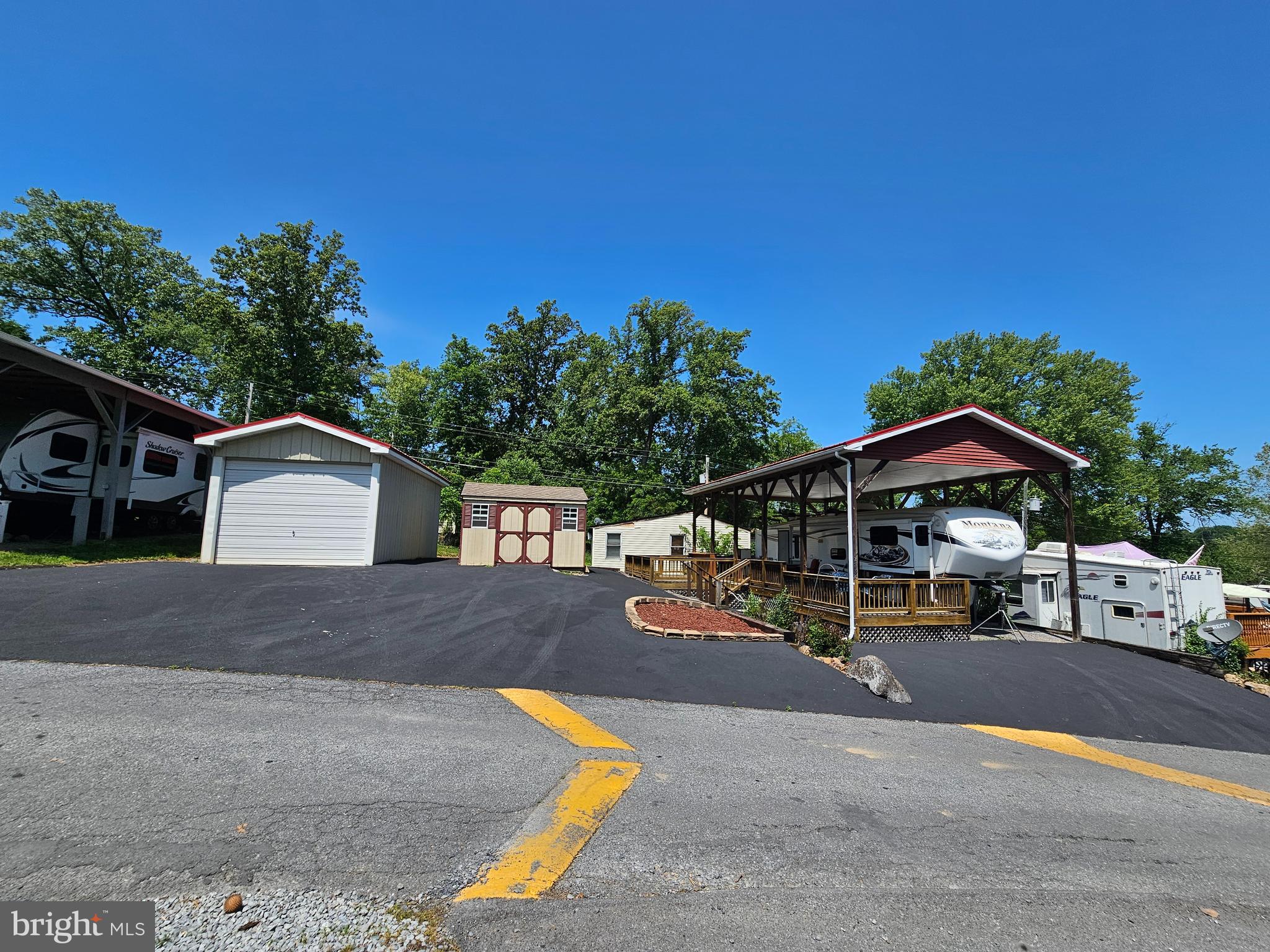 Financing May be available

Welcome home to your seasonal home away from home Block 24 lots 19 & 20 Poison Oak (ON SEWER) sitting on a fully paved and sealed double lot in Riverbends Rv Campground. Riverbend is 400 Acres of SEASONAL recreational campground full of amenities located on the Potomac River in Falling Waters, Wv. OPEN APRIL 1 - NOVEMBER 1 - This is a fun & entertaining community, yet relaxing. 

Extremely well taken care of double lot, fully paved and sealed means no lawn mowing when you come to relax. You must truly see this one in person to appreciate all of the custom features. Block 20 has a huge 24*40 ft stick-built pavilion 6*6 Posts with a metal roof, gutters and downspouts, vinyl ceiling, 3 ceiling fans with lights and remotes to keep that summer air flowing. This massive space not only houses a multi - level deck for lots of entertainment space, outdoor kitchen area and more but it also is home to a 2016 CUSTOM built 40 ft Montana 5th wheel (They don't make them like this). This camper also has never been out in the weather outside of the pavilion and has the custom underbelly to withstand negative temperatures. Trimmed with Red Oak throughout the entire camper, she is sure to wow ya. Dual A/C & Heating units. Large sectional sofas in the living room, one pulls out to a bed, has electric fireplace for those chilly nights. This living room even has a built-in room divider for privacy when using it as a 2nd bedroom. A step down into the kitchen area, you'll find a build-in fold down desk area, extending dining room table, Granite counters, Double porcelain under the counter sink, Cherry Oak cabinets, LARGE French Door Refrigerator and Freezer, full standard Convection/ microwave, and lots of storage space. Full Standard size bathroom with it's own entry / exit for easy access. The bathroom hosts a large closet with apartment size washer and dryer, standard home toilet, and a spacious stall shower. The back bedroom is nice to be far from the road and has a new $1,000 King size mattress, its own A/c & heating unit, plenty of cedar closet and dresser space as well as custom blinds. Direct Tv is an option here as well. These lots show their value very well. On lot 19 Out back behind the 10 *12 shed (w/ electric) is a private campfire area with 2 custom firewood storage bins. There is also a 12 * 24 Steel building with electric that is large enough to house a boat and golf cart or you can turn it into extra living space. Schedule your tour today! Approx. 10 miles of Deep water on the Potomac River access for boating, fishing & swimming. Yearly membership ($1,987) plus a $200 initiation fee for new owners, includes water, sewer, electric, trash and the park amenities such as 3 pools, putt putt course, Horseshoe club, Boat club, Poker runs, Trick or Treat, Christmas in July, live bands, basketball court, tennis court, fireworks, car show, Church, restaurant, bar, convenience store (Great food), playground, volleyball, ball field and much much more. Join Riverbend Boat Club. Bring your golf carts, water toys and come enjoy life!