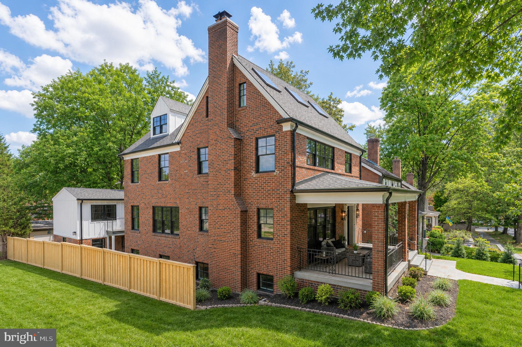 Set within the Observatory Circle neighborhood, this fully reimagined residence delivers the feel of new construction with the scale, flexibility, and craftsmanship of a bespoke renovation completed in 2025. Thoughtfully redesigned across four finished levels, the home offers five bedrooms, five-and-a-half baths, exceptional versatility for modern living, and the rare benefit of a fully separate one-bedroom accessory dwelling unit above a three-car garage.

A dramatic entry foyer with white oak herringbone flooring introduces a calm, refined interior that immediately creates a sense of separation from the surrounding city. Expansive living and dining spaces feature nine-foot ceilings, a quartz-clad fireplace, custom built-ins, a wet bar, and a striking 30-foot window wall that fills the home with natural light while reinforcing privacy.

The chef’s kitchen is both architectural and highly functional, anchored by a six-burner BlueStar professional gas range and complemented by professional-grade appliances, two-tone custom cabinetry, Cristallo quartzite countertops, a bespoke hood, and statement lighting—equally suited to daily living and entertaining. A discreet powder room completes the main level.

The primary suite serves as a private retreat, offering a generous bedroom, dual walk-in closets, and a spa-inspired bath finished in Terrazzo Italy Sacra Bianco and Calacatta Fioressa quartz. An additional ensuite bedroom and a full laundry room complete the second level, while the third floor hosts two more ensuite bedrooms designed for privacy and comfort.

The terrace level enhances the home’s flexibility with a media and lounge space, a Cambria Woodcroft wet bar, guest suite, mudroom, secondary laundry, and a concealed wine cellar integrated behind custom millwork.

Above the garage, a fully independent accessory dwelling unit provides a complete one-bedroom suite with its own kitchen, bath, HVAC system, and private entrance—ideal for guests, extended family, an au pair, or long-term use.

Outdoor spaces are unusually generous for the location, including a partially screened flagstone terrace, connecting deck, side yard, and direct access to the three-car garage—creating a layered indoor-outdoor lifestyle rarely found this close to the city.

Perfectly positioned near Georgetown, downtown Washington, and an exceptional collection of shops, restaurants, parks, and everyday conveniences, the home offers a rare balance of privacy, walkability, and connectivity—delivering a refined urban lifestyle within an established, mature neighborhood.