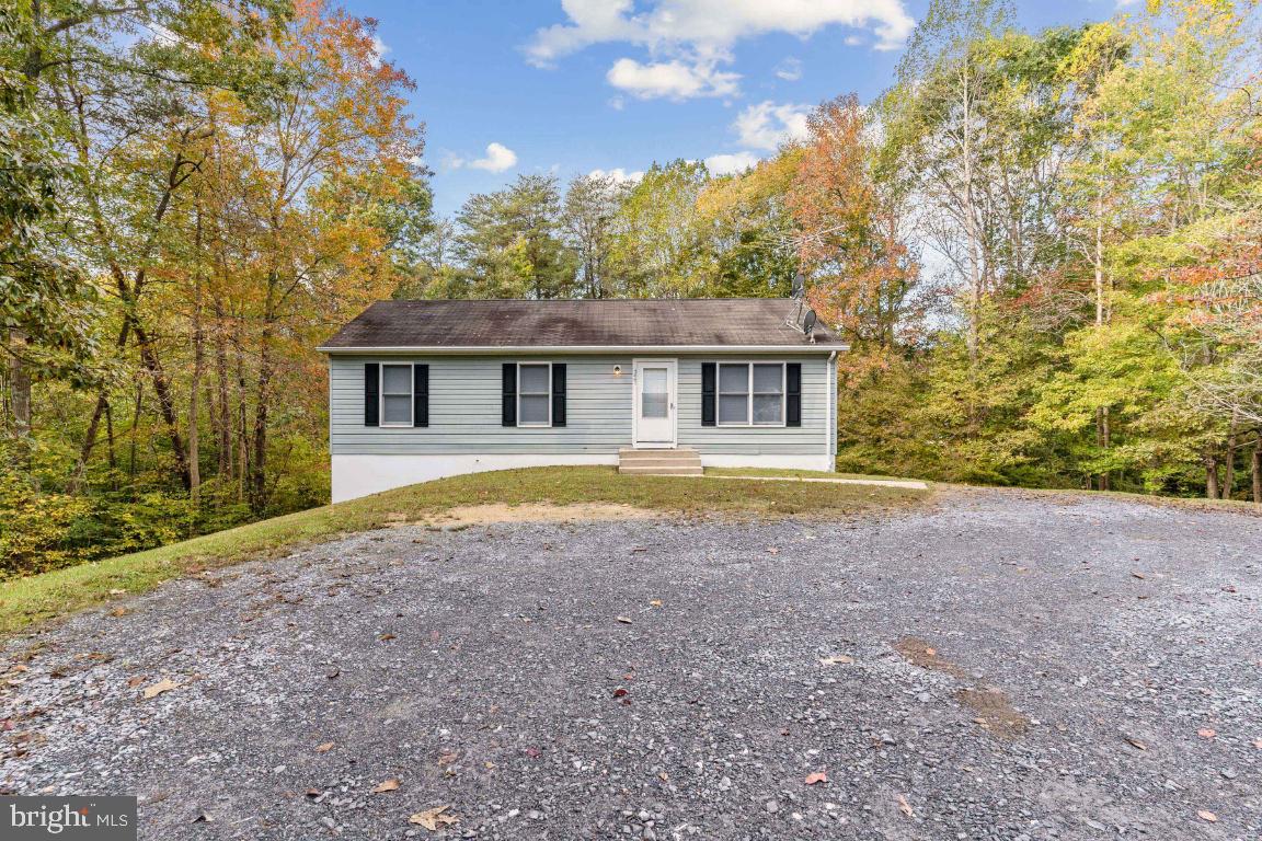 Very Nice home located on 1.39 Acres.  Freshly painted through out.  Updated Bathroom, New vanity, Tile flooring and Toilet.  New Carpet Throughout, New Ceiling Fans and New Mini Blinds.   Hot Water Heater was replaced 2019.   Unfinished Basement with a walkout.  The Kitchen has french doors waiting for your personal touch.  You will fall in love with the Expansive acreage!