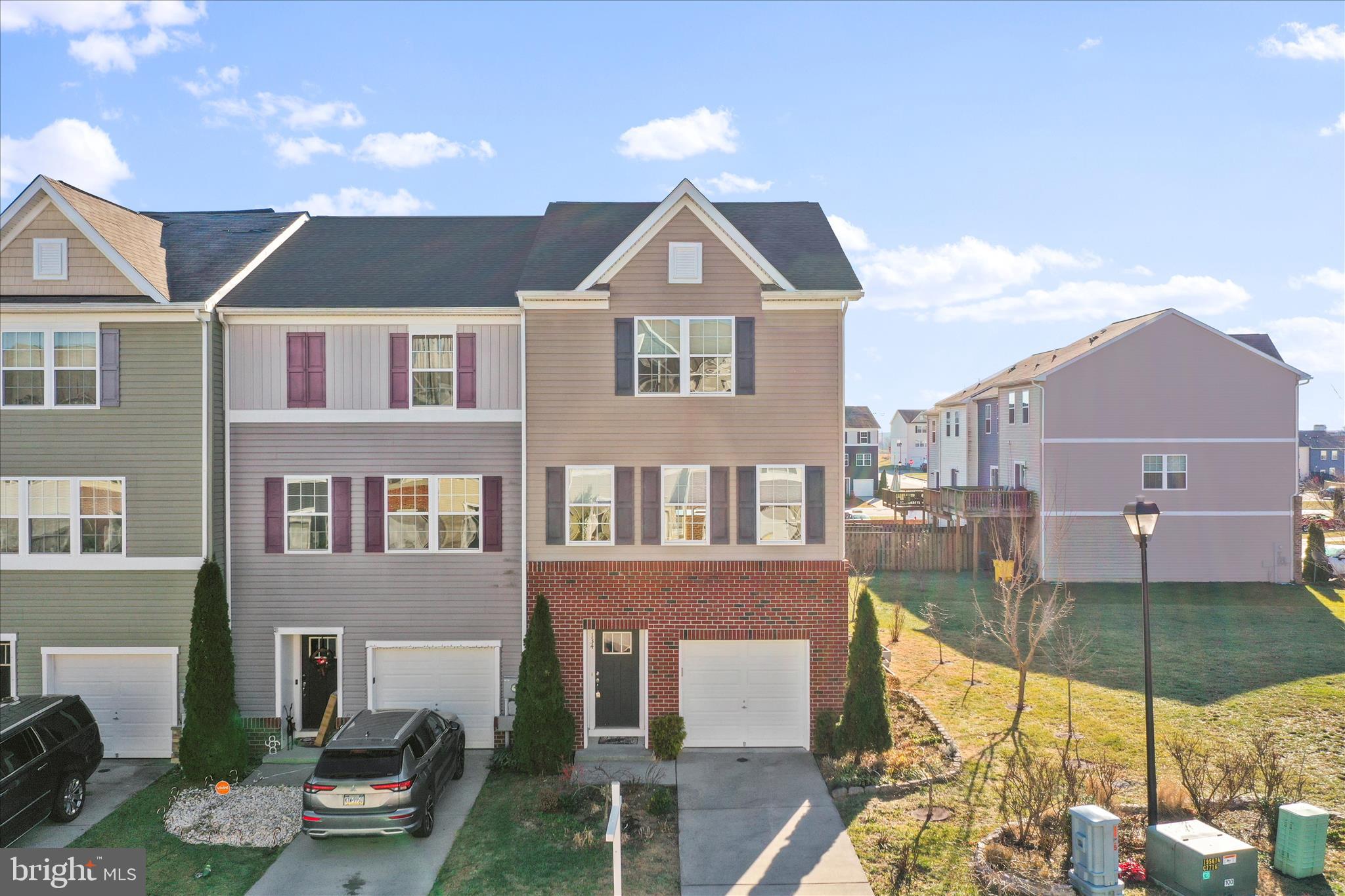Welcome to 134 Drexel Court, a stunning three-level townhome in desirable Berkeley
Ridge. Built in 2016, It is located on one of the largest lots and is an end unit.
This single owner brick exterior town home with charming gable detail, and single car
attached garage with electronic door opener, creates an inviting curb appeal. The
outdoor space includes mature trees, flower gardens, raised bed gardens, and elevated
rear deck, providing plenty of room for entertaining or relaxing.
Inside, the entry level features a den with an attached half bath that is perfect for
guests, teens, or a home office. There is an interior entrance to the attached one car
garage. The den opens to the community playground, common green space, and
additional overflow parking available located in the rear.
The main living area showcases an open-concept design ideal for modern living and is
enhanced by nine-foot ceilings that create an open and airy feel.
Up-graded kitchen includes stainless appliances and serves as the heart of the home,
featuring a massive, gorgeous island with overhang for bar stool seating, a pantry, a
powder room, and sliding glass doors that lead to the deck.
The adjacent living room feels bright and welcoming with three large front windows in
the front and two on the side that fill the space with natural light. The entire level is
finished with durable, stylish luxury vinyl plank flooring for a cohesive look throughout.
The upper-level hosts three fully carpeted bedrooms and two full bathrooms with vinyl
flooring, including a spacious primary suite with a walk-in closet and a luxurious en-suite
bath featuring a dual quartz vanity and a tiled walk-in shower. The secondary bath also
includes a tiled shower for a touch of refinement throughout the home. Laundry hookup
is located on the upper bedroom level for added convenience.
Located in the desirable Berkeley Ridge community, this home is just steps from
schools, WVU Urgent Care with other services, Valley Health medical facilities,
restaurants, and Walmart shopping, with easy access to I-81, I-70, and I-270.
Commuting to Maryland or Virginia is quick and easy. 
Discover why this Berkeley Ridge beauty will not last long. Schedule your showing today!