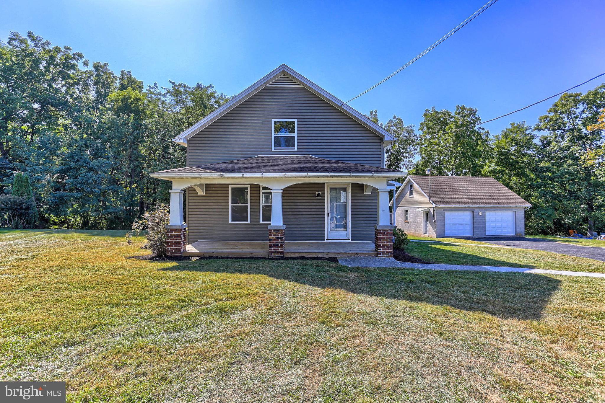 WHAT A FIND!  Close to town on HALF ACRE in South Western School District!  This country farmhouse has a main floor bedroom and three more rooms on second floor, with a full bathroom on each floor.  Large country kitchen, formal dining room, and living room!  Full basement with tall ceilings and two exits, easy to finish!  Covered porch spans the entire front of home, plenty wide for relaxing  on your outdoor furniture arrangements! Back yard is private, tree-lined, and includes a small CREEK!  Separate detached garage is over-sized for your vehicles and/or workshop! Parking abounds with the long driveway.  An older home on more than a postage stamp lot is hard to come by.  New roof and windows too!   Make an appointment to see if this home is for you!!